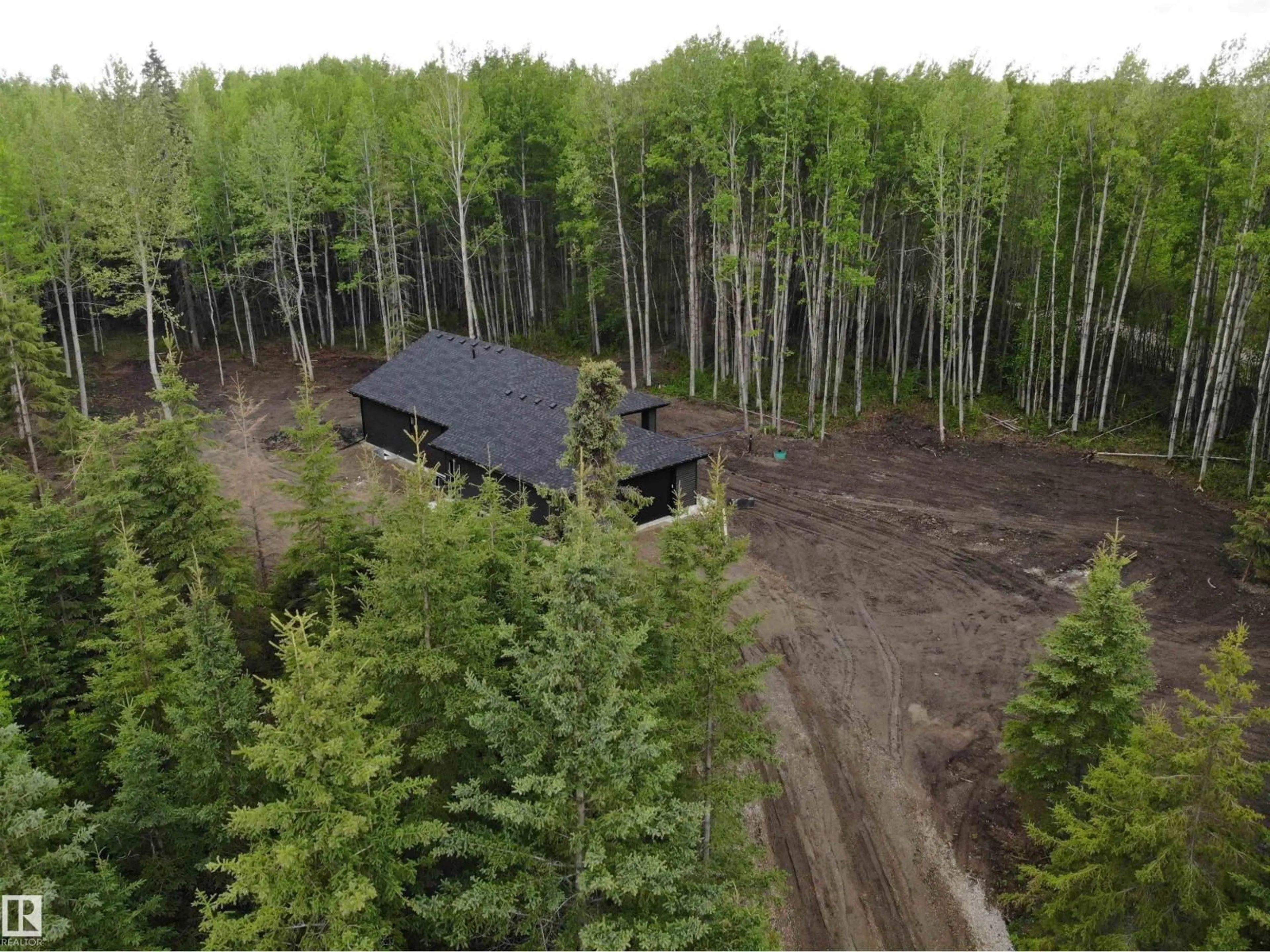 A pic from outside/outdoor area/front of a property/back of a property/a pic from drone, forest/trees view for 37 - 420 1414 HWY, Rural Lac Ste. Anne County Alberta T5A1H3