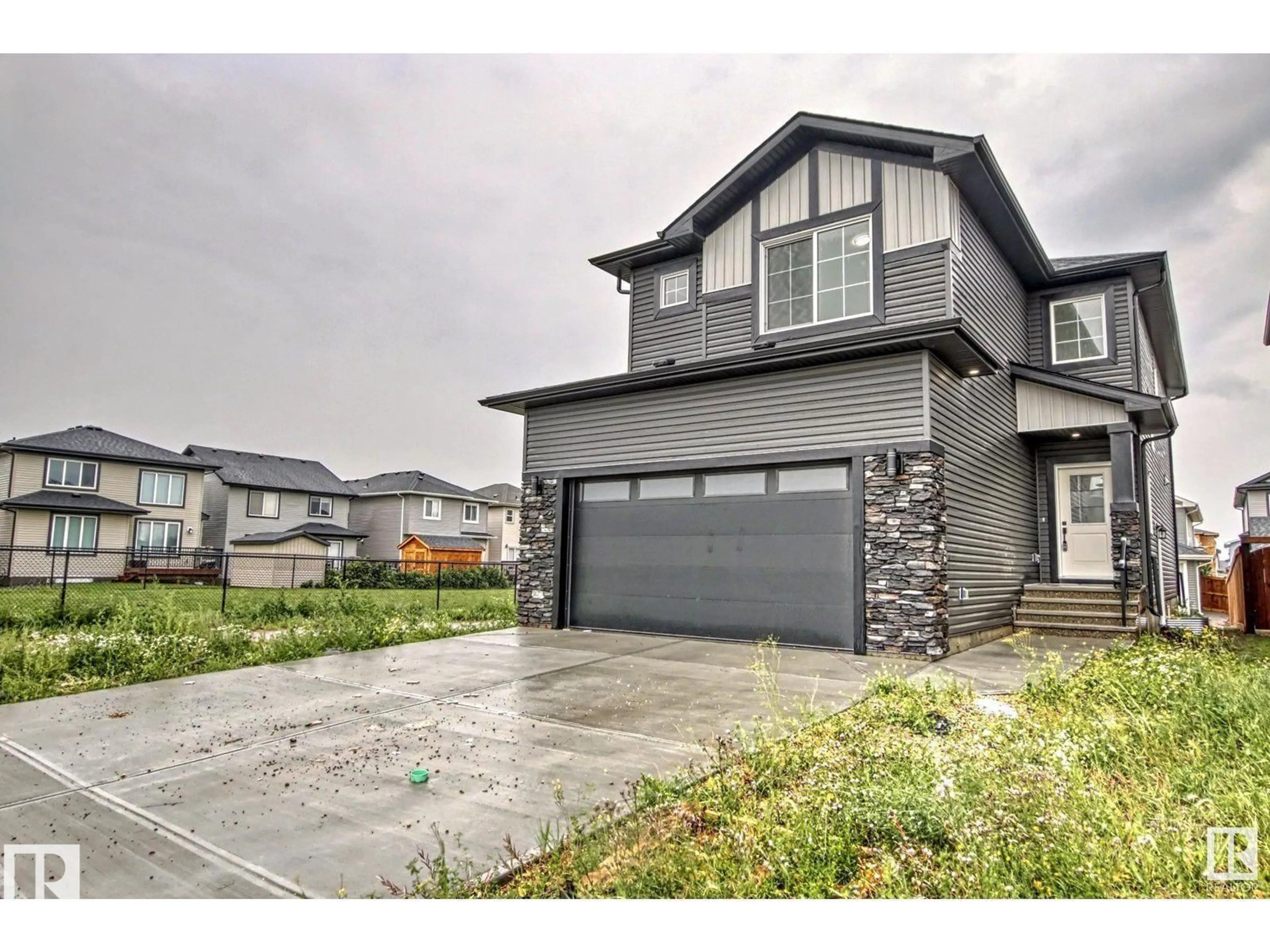 Home with vinyl exterior material, street for NW - 1703 152 AV, Edmonton Alberta T5Y2R7