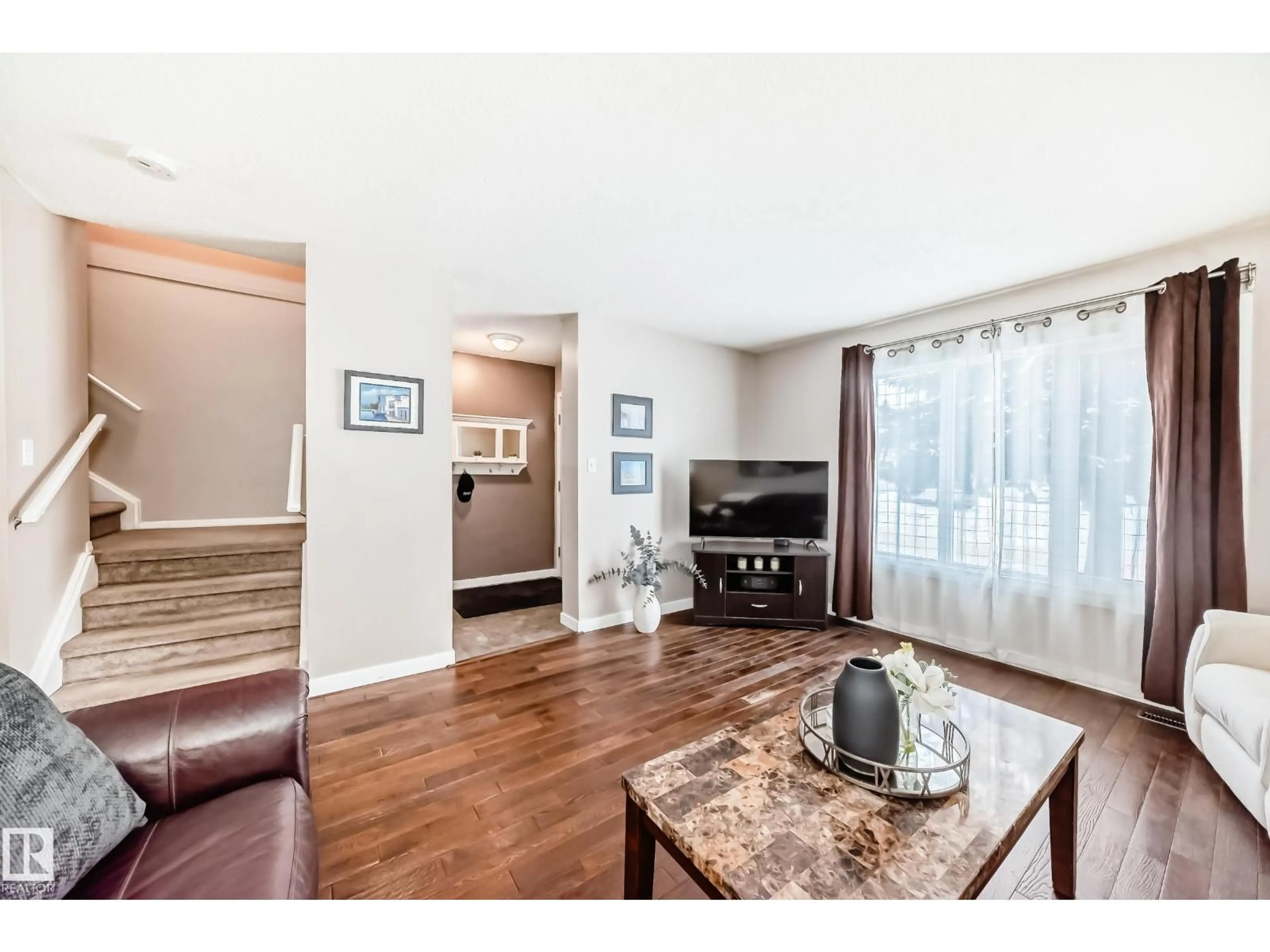 Living room with furniture, wood/laminate floor for NW - 16413 115 ST, Edmonton Alberta T5X5E8