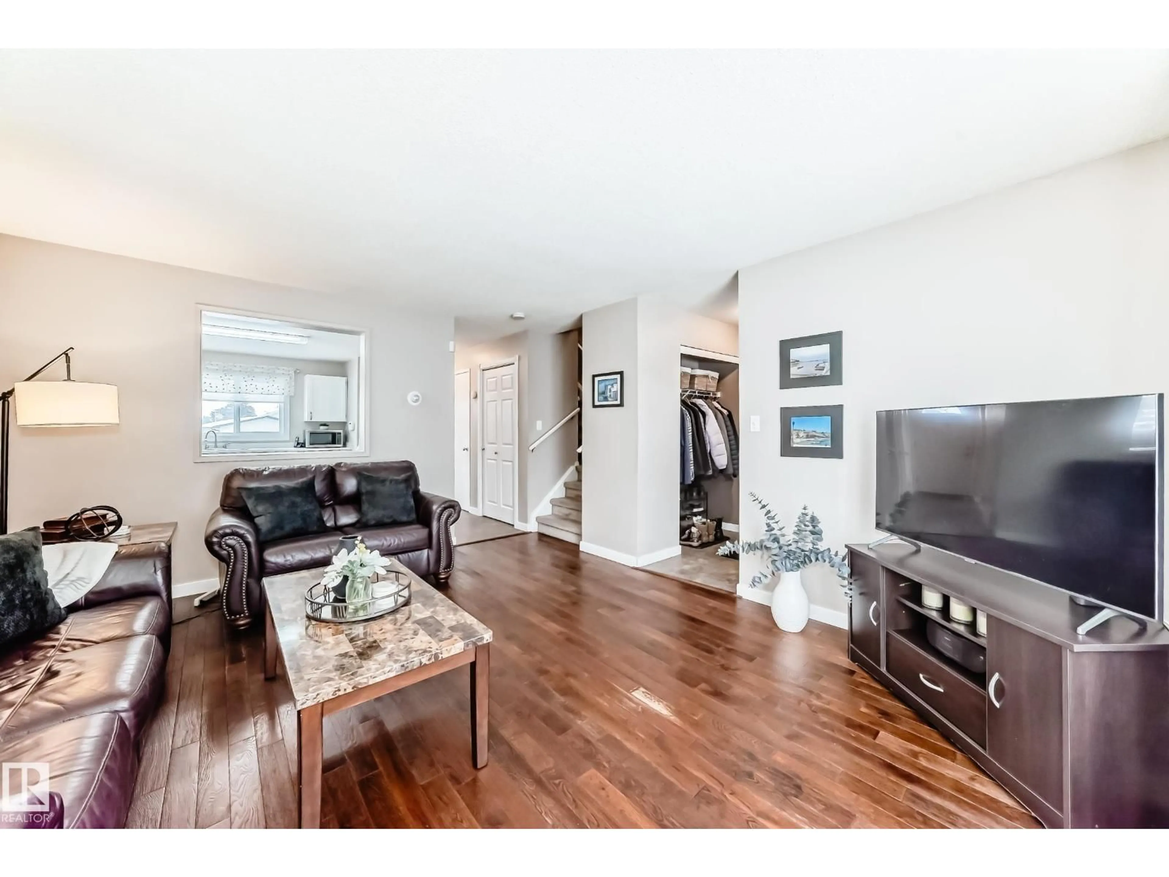 Living room with furniture, wood/laminate floor for NW - 16413 115 ST, Edmonton Alberta T5X5E8