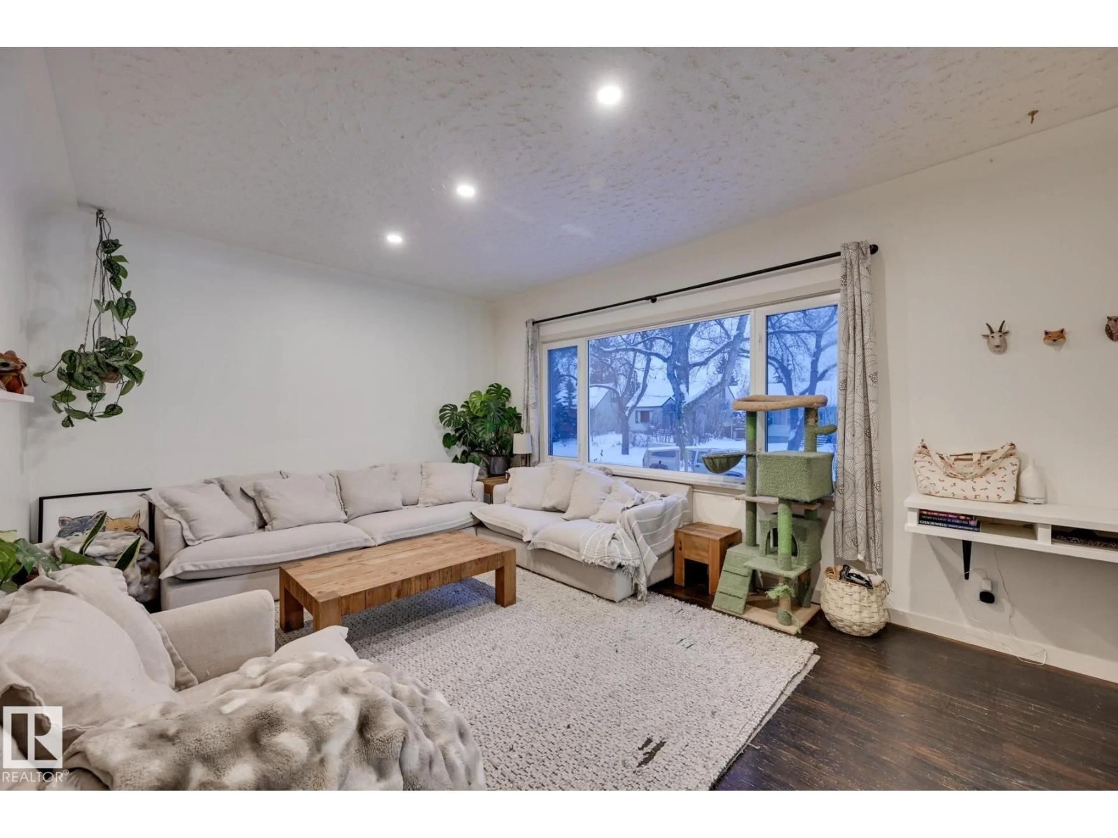 Living room with furniture, wood/laminate floor for 13324 109A AV, Edmonton Alberta T5M2J6