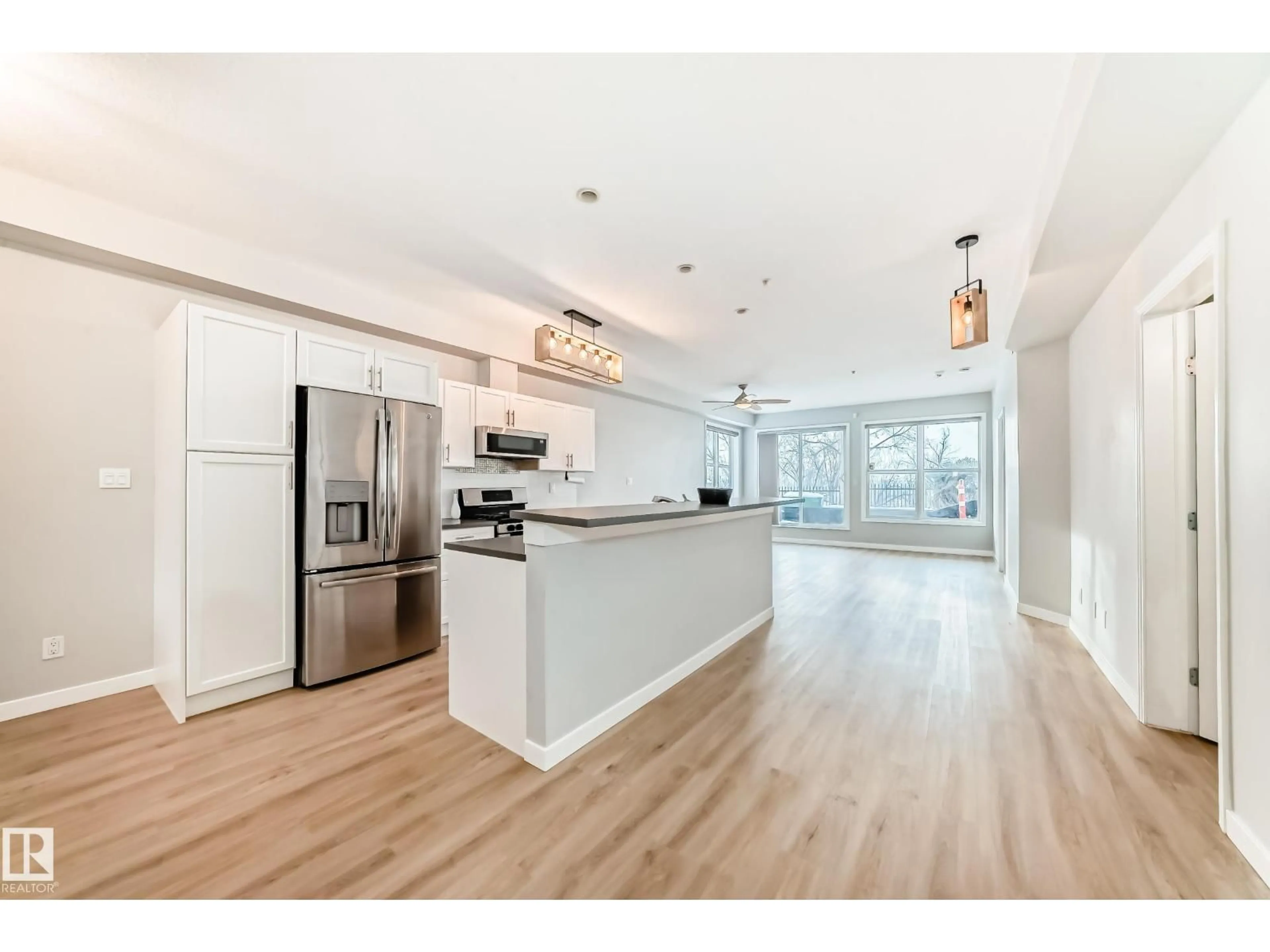 Open concept kitchen, wood/laminate floor for #115 - 9507 101 AV, Edmonton Alberta T5H4R1