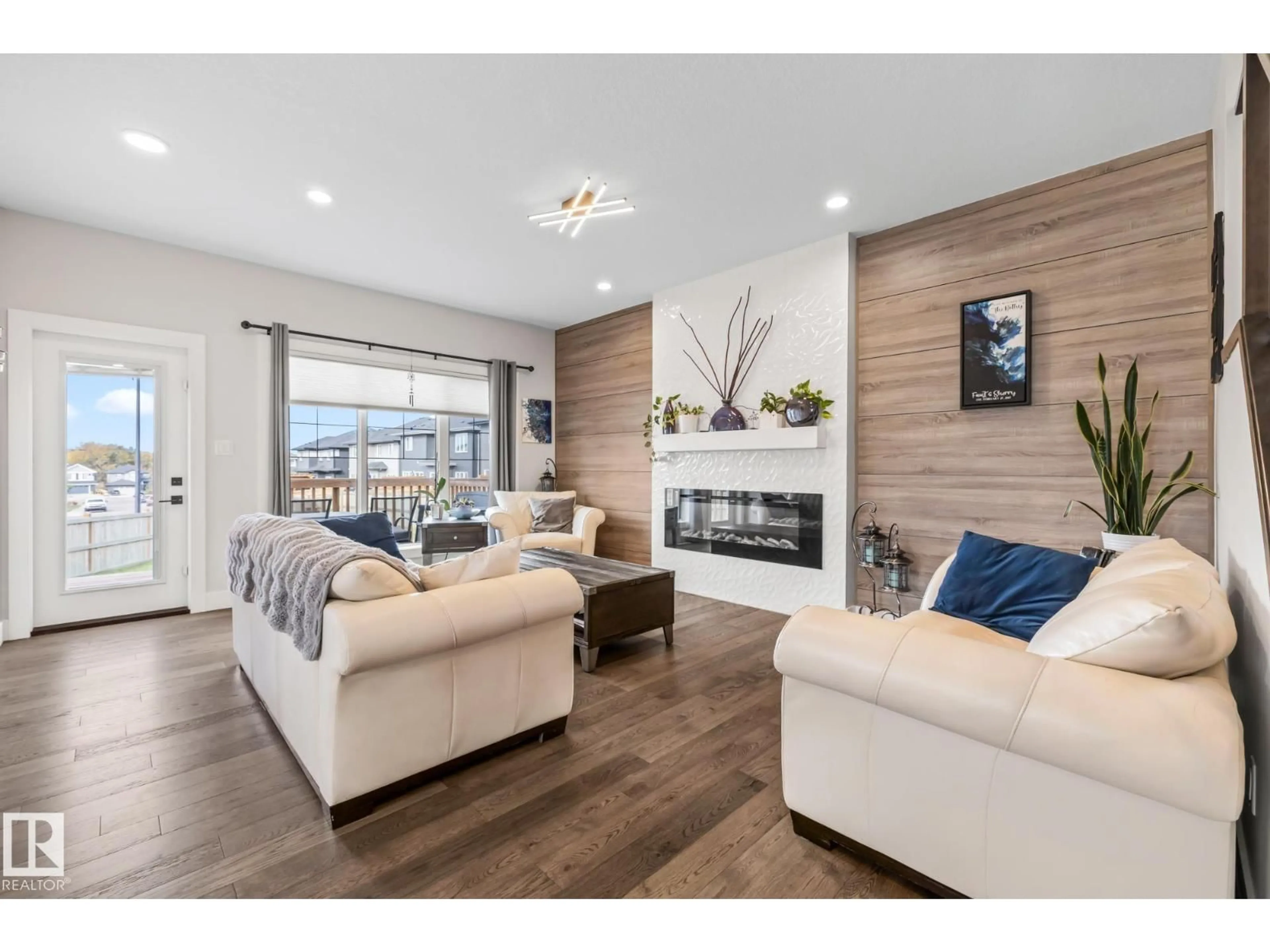 Living room with furniture, wood/laminate floor for 568 MERLIN LANDING LD, Edmonton Alberta T5S0L9