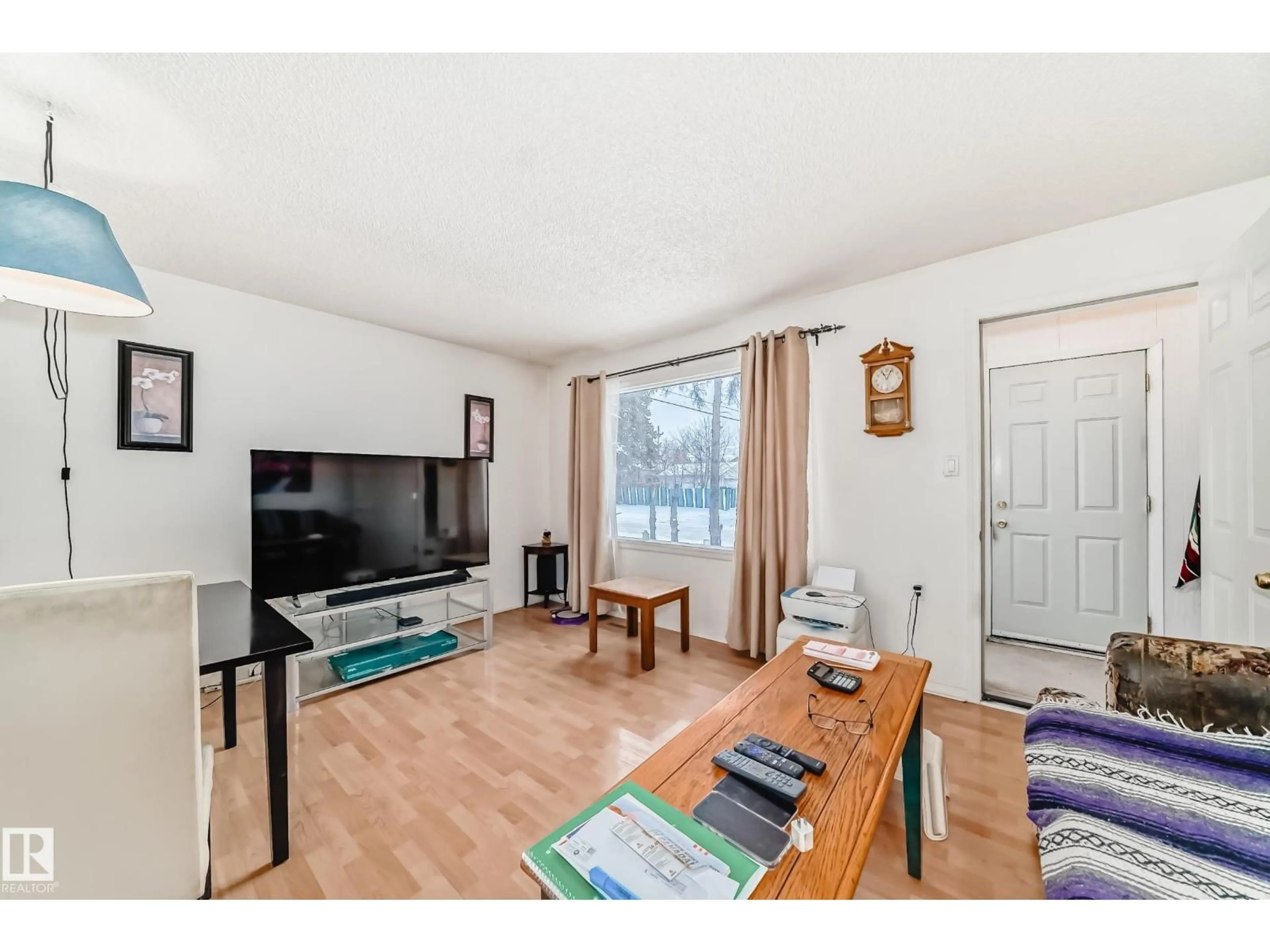 Living room with furniture, wood/laminate floor for 15515 92A AV, Edmonton Alberta T5R5E8