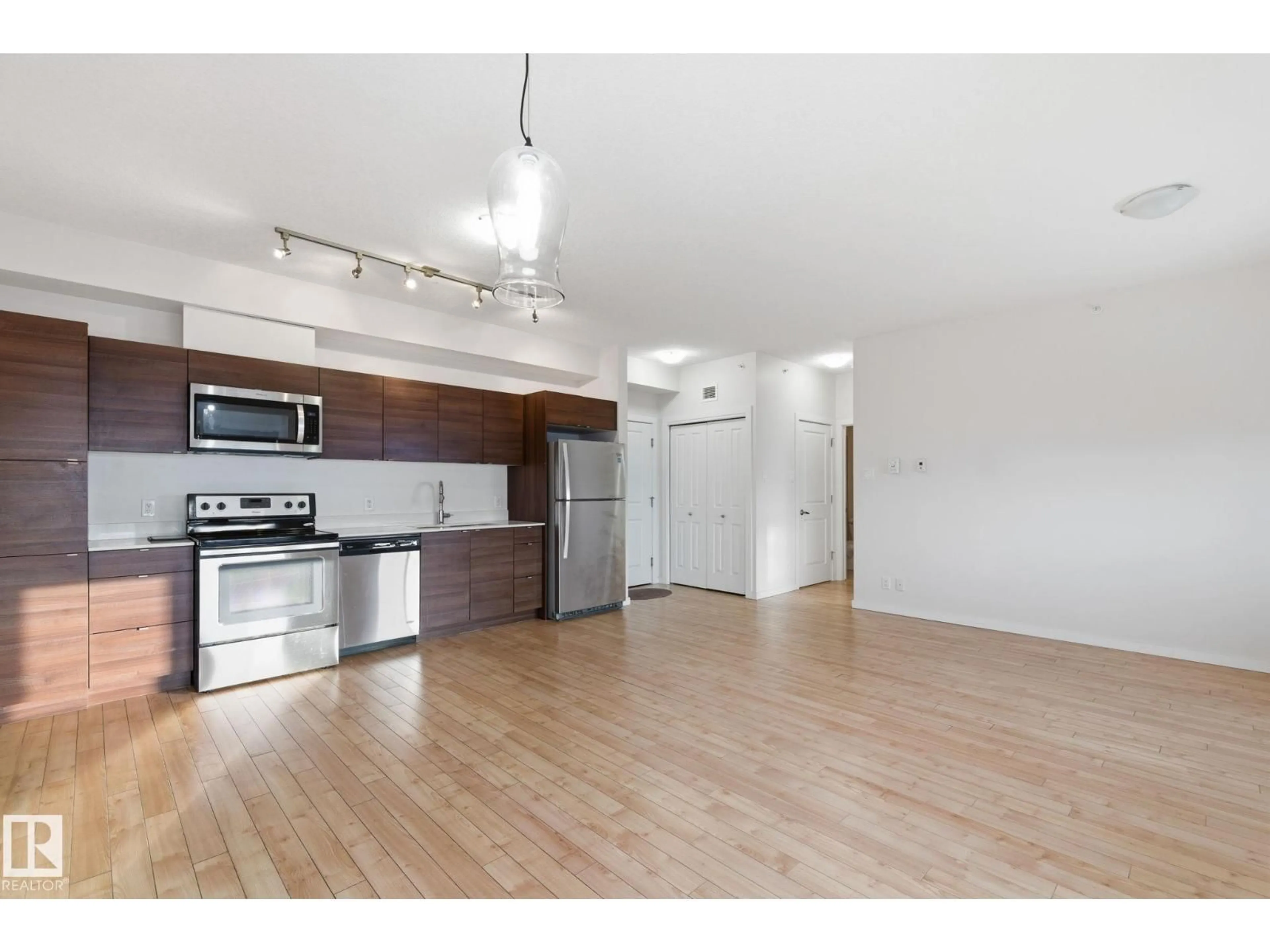 Open concept kitchen, wood/laminate floor for #405 - 9517 160 AV, Edmonton Alberta T5Z0N1