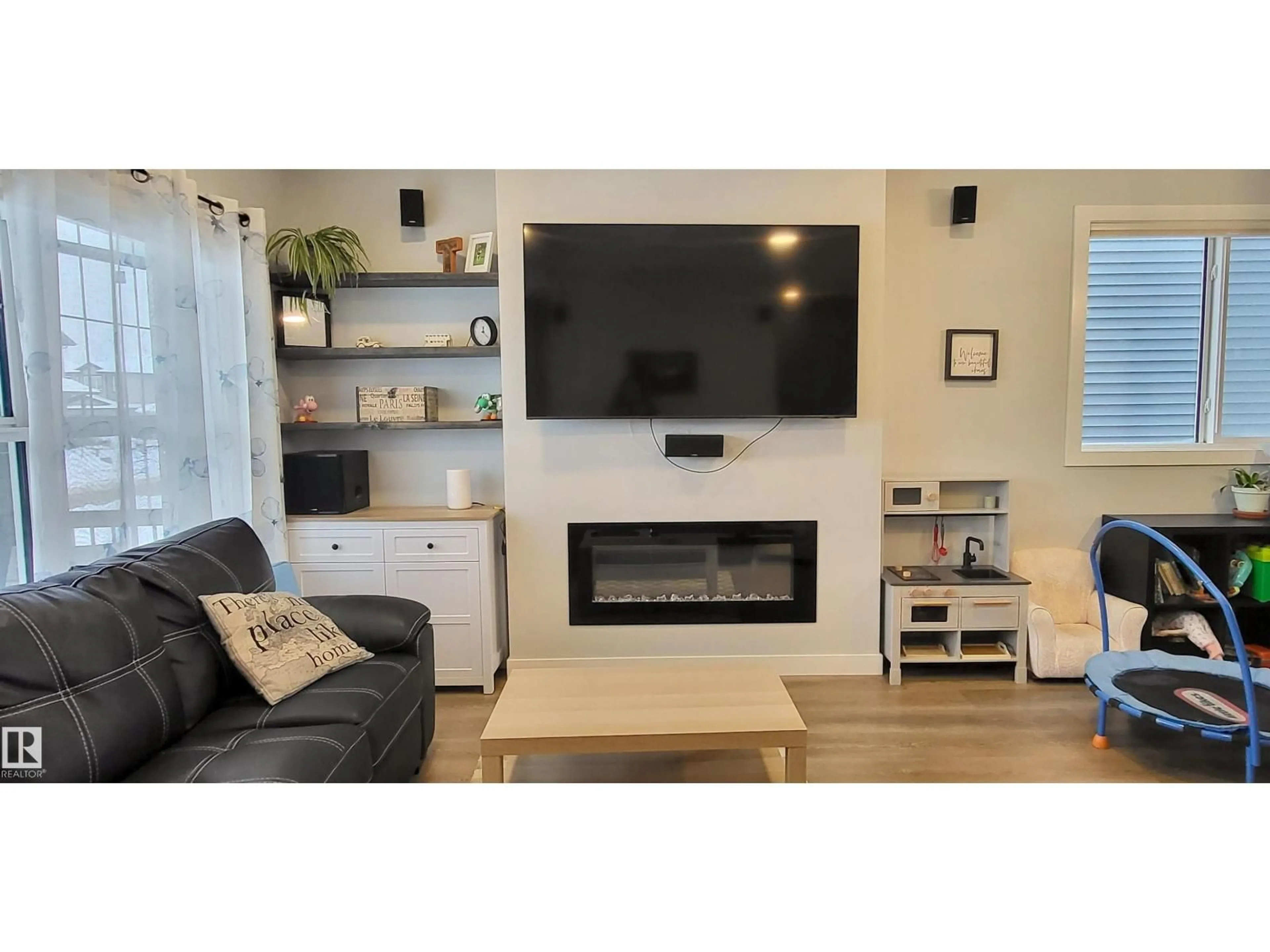 Living room with furniture, wood/laminate floor for 663 LEWIS GREENS DR, Edmonton Alberta T5T7G3