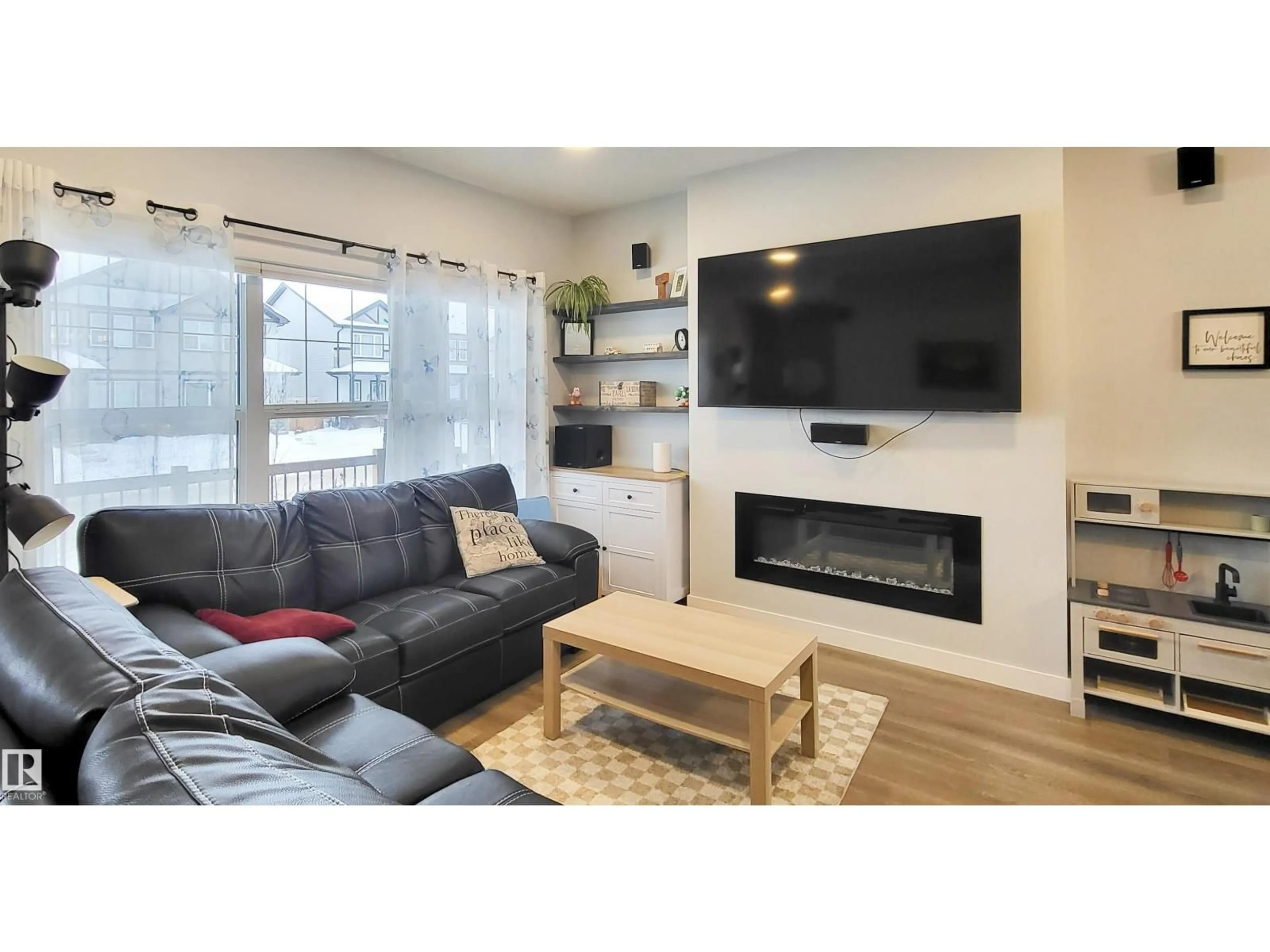 Living room with furniture, wood/laminate floor for 663 LEWIS GREENS DR, Edmonton Alberta T5T7G3