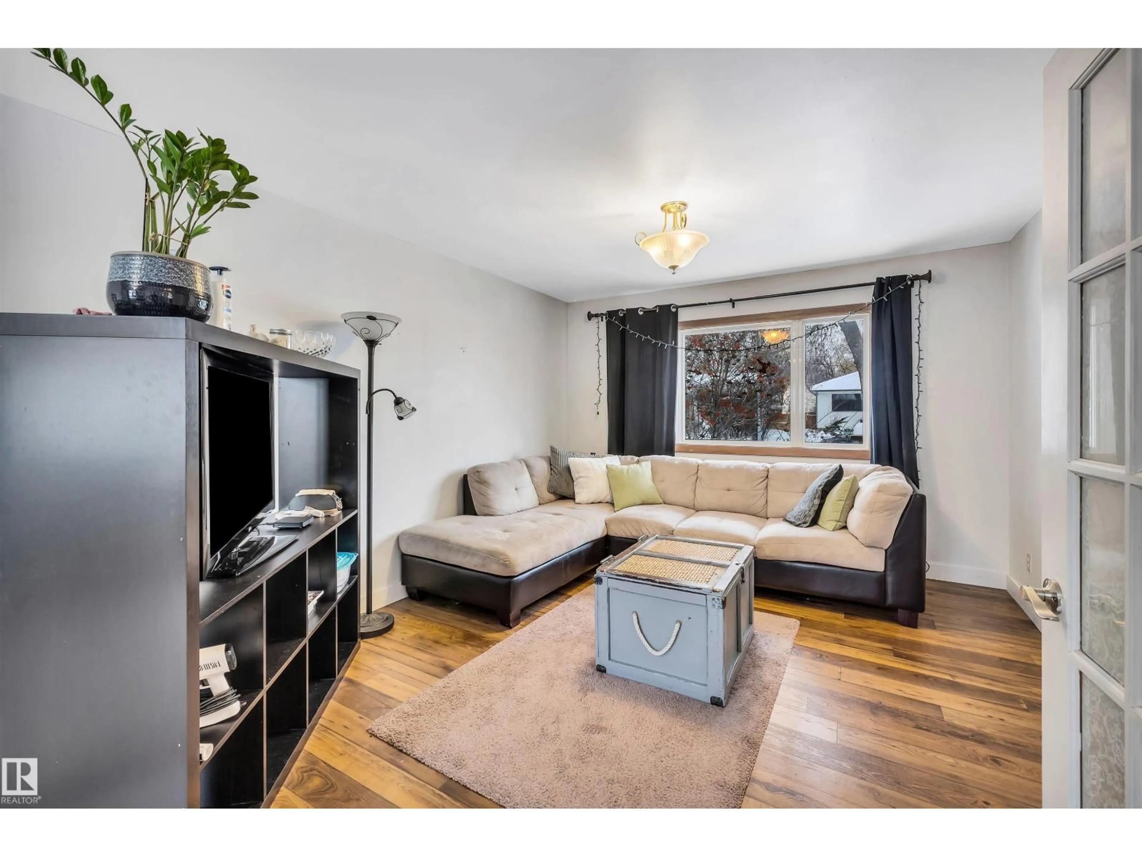 Living room with furniture, wood/laminate floor for 12237 47 ST, Edmonton Alberta T5W2X6