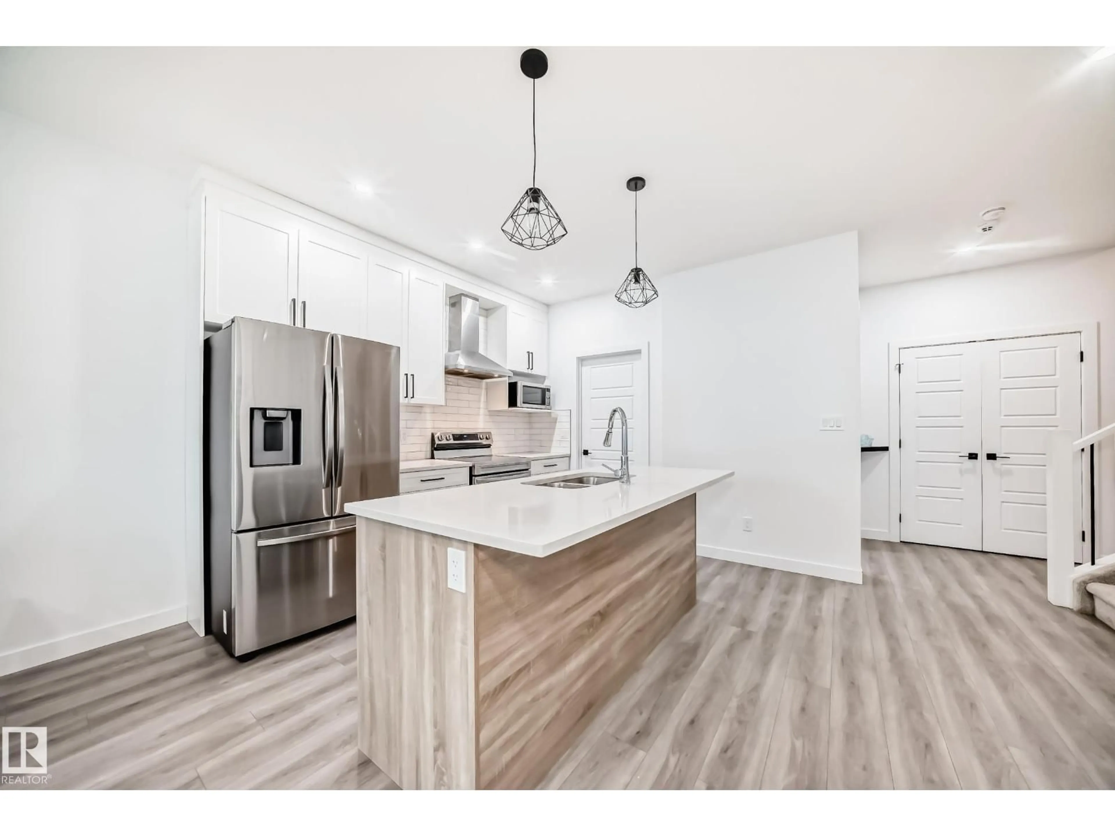 Open concept kitchen, wood/laminate floor for 563 KLEINS CR, Leduc Alberta T9E1J4