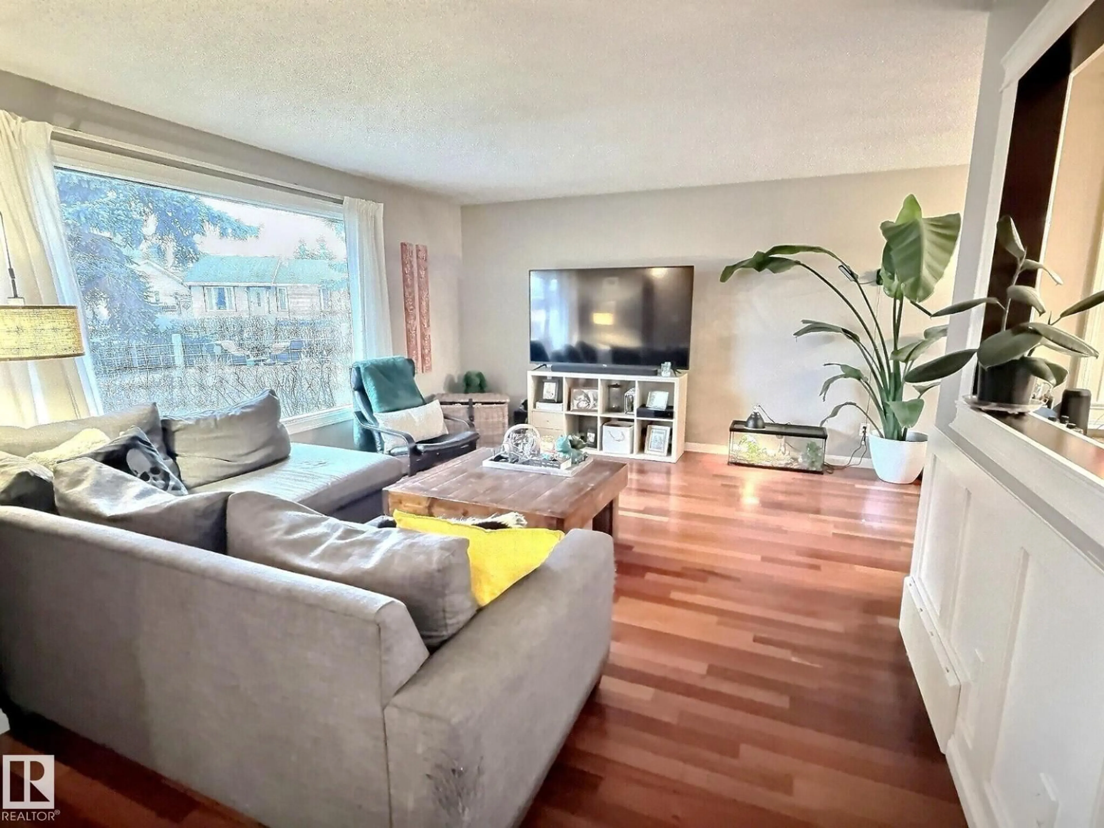 Living room with furniture, wood/laminate floor for NW - 1712 36 ST, Edmonton Alberta T6L2P5
