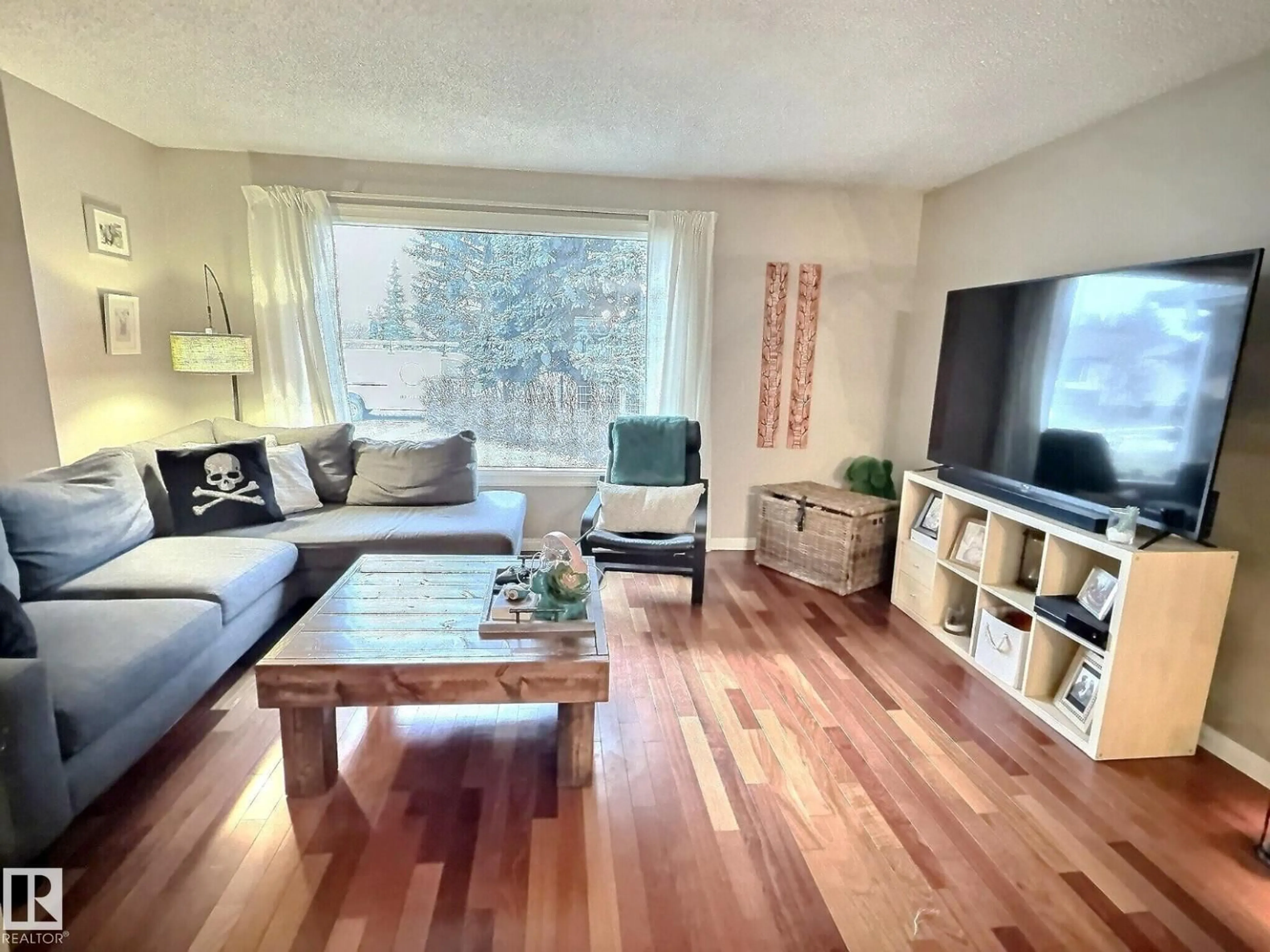 Living room with furniture, wood/laminate floor for NW - 1712 36 ST, Edmonton Alberta T6L2P5