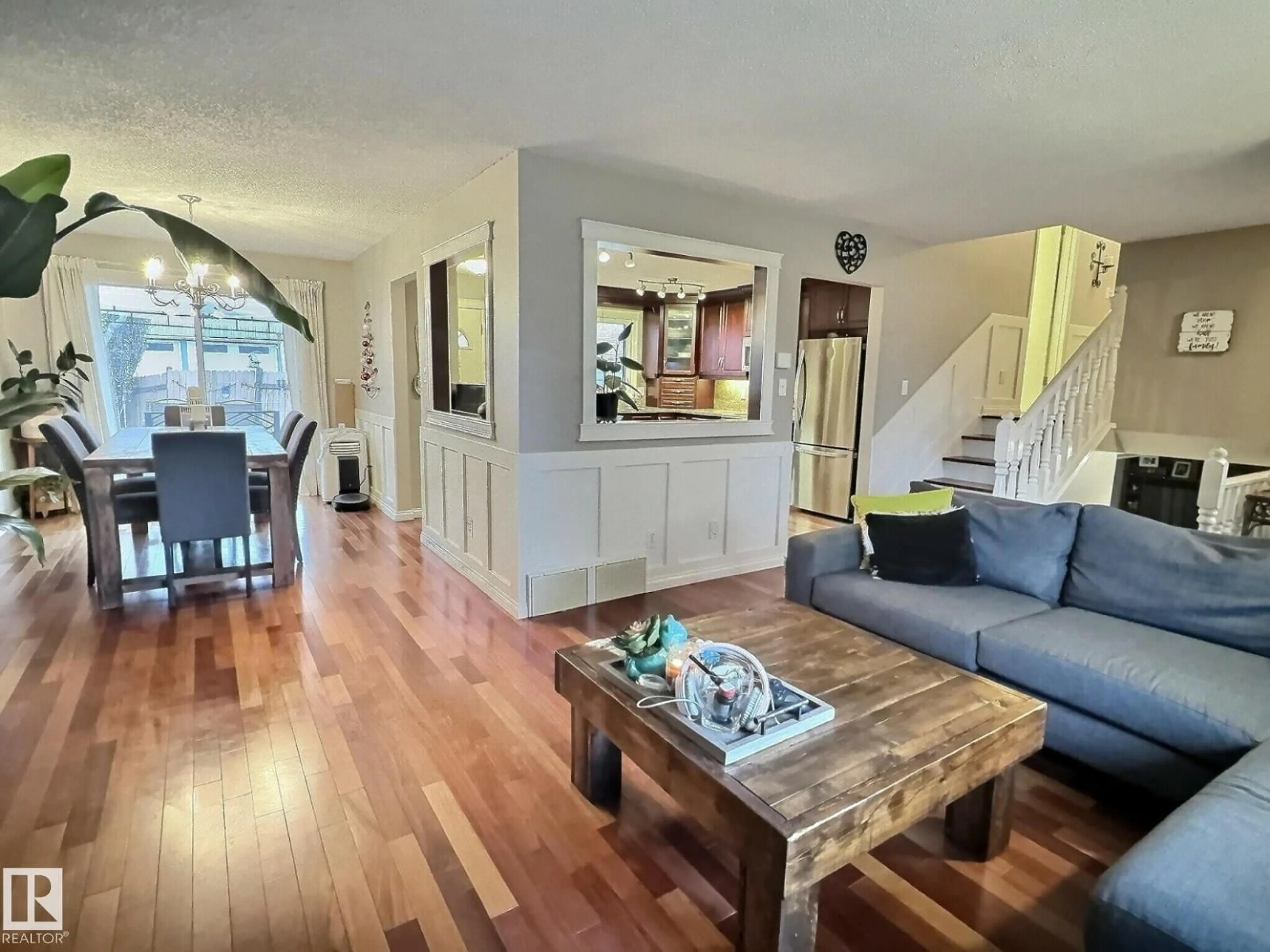 Living room with furniture, wood/laminate floor for NW - 1712 36 ST, Edmonton Alberta T6L2P5