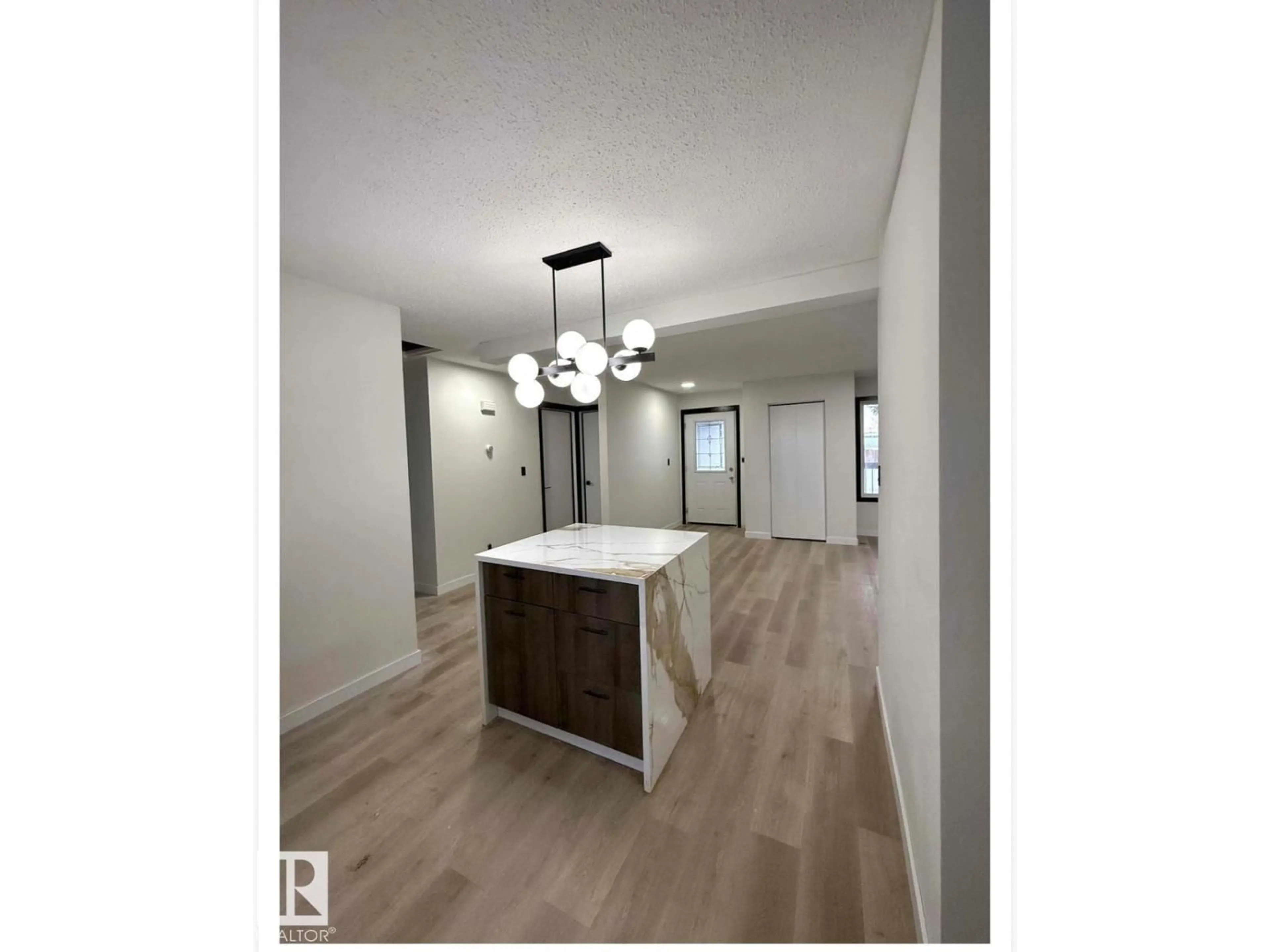 Open concept kitchen, wood/laminate floor for NW - 11628 151 AV, Edmonton Alberta T5X1C6