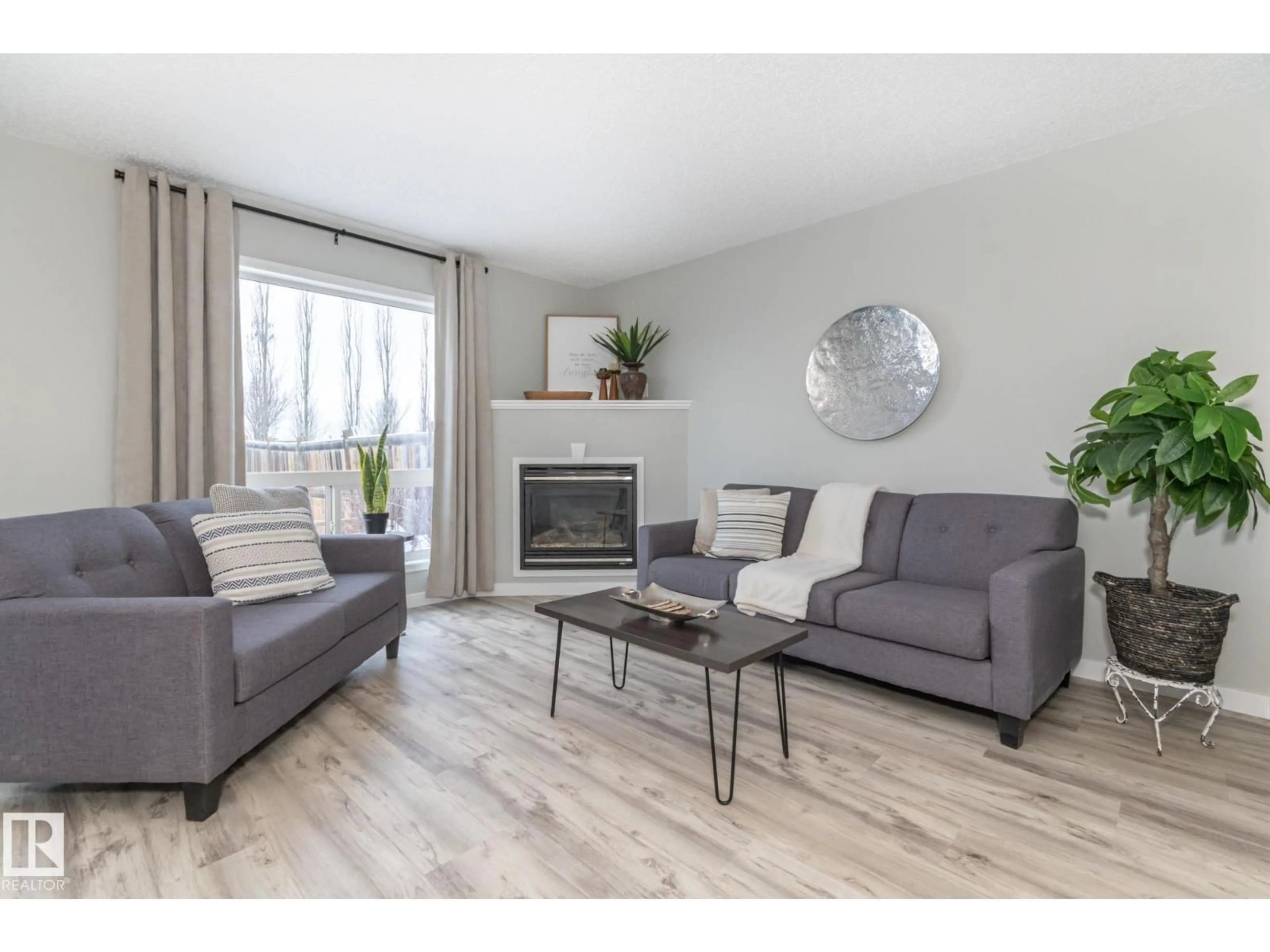 Living room with furniture, wood/laminate floor for 31 GALLOWAY WD, Fort Saskatchewan Alberta T8L0A3