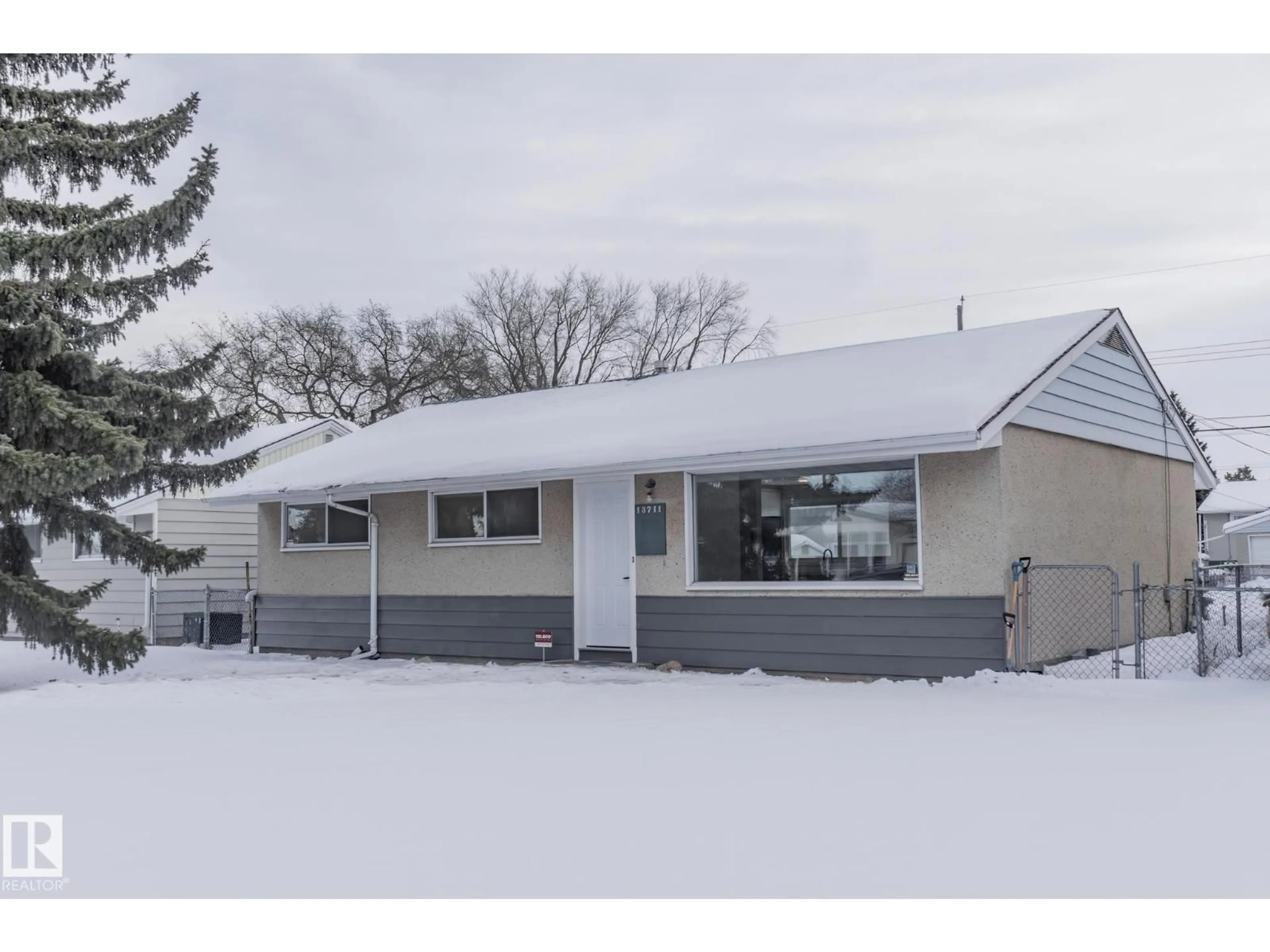 Home with vinyl exterior material, street for NW - 13711 133 AV, Edmonton Alberta T5L3T3