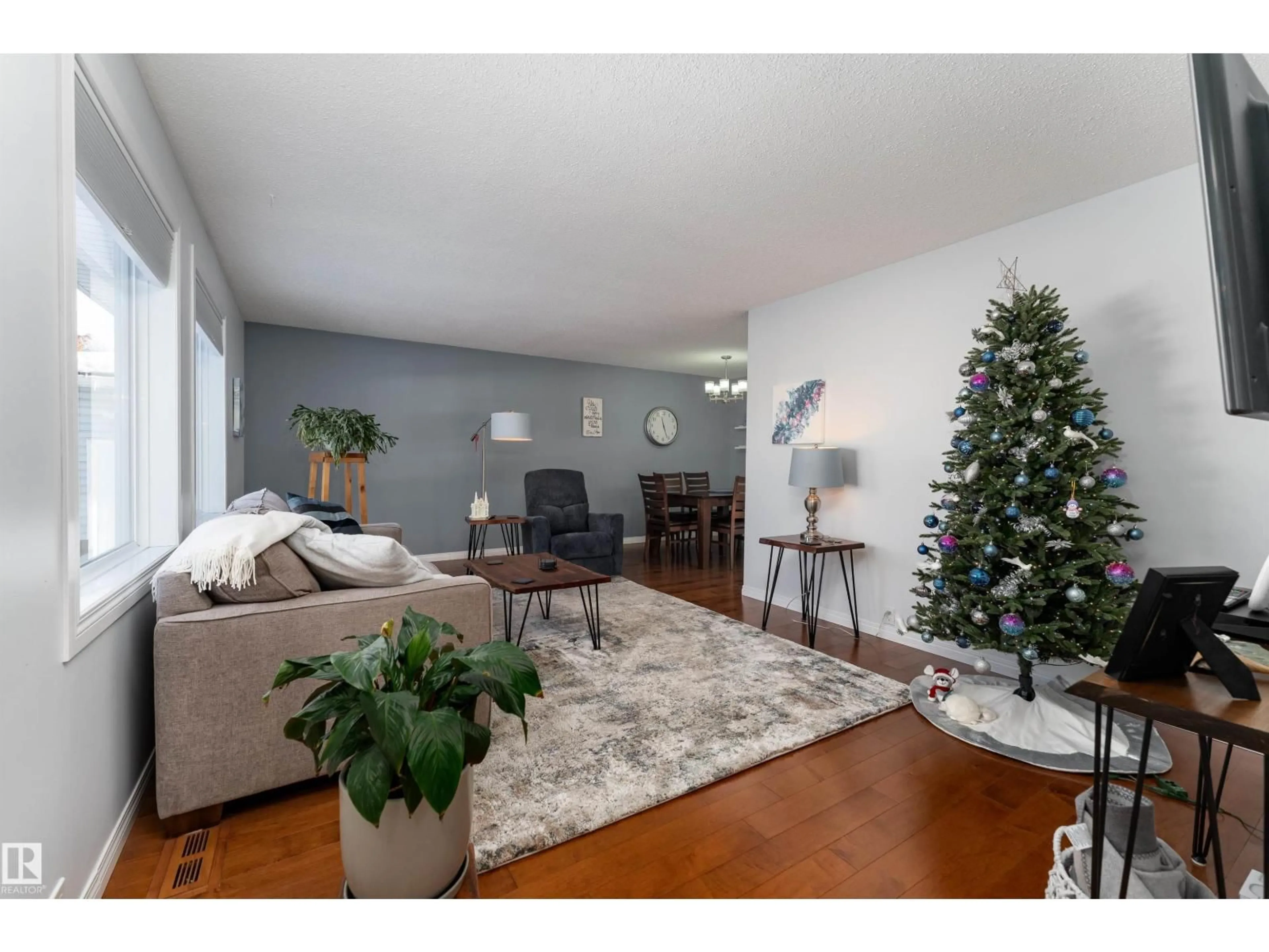 Living room with furniture, wood/laminate floor for 8973 95 AV, Fort Saskatchewan Alberta T8L1C4