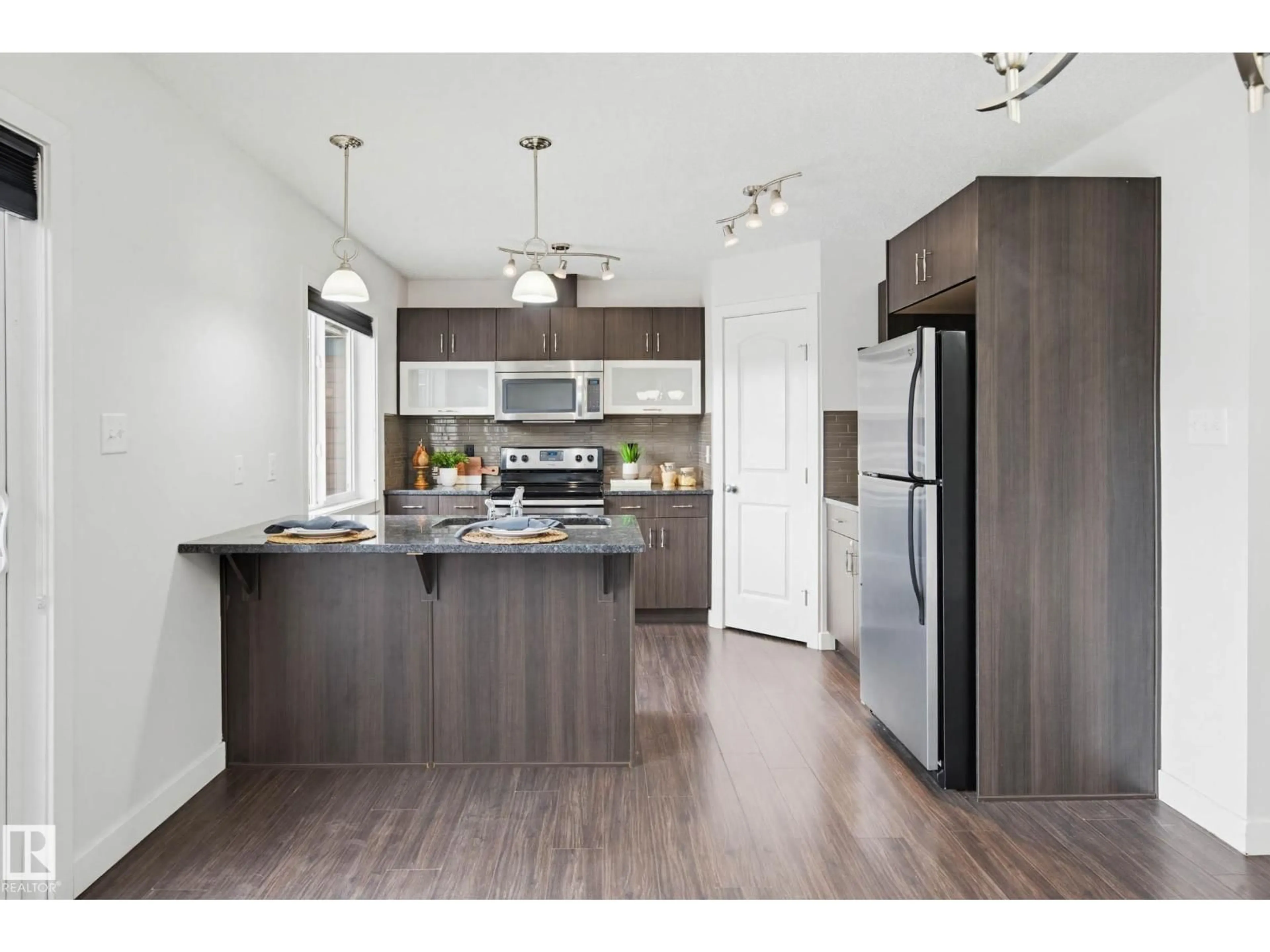 Open concept kitchen, wood/laminate floor for 68 301 PALISADES WY, Sherwood Park Alberta T8H0T4