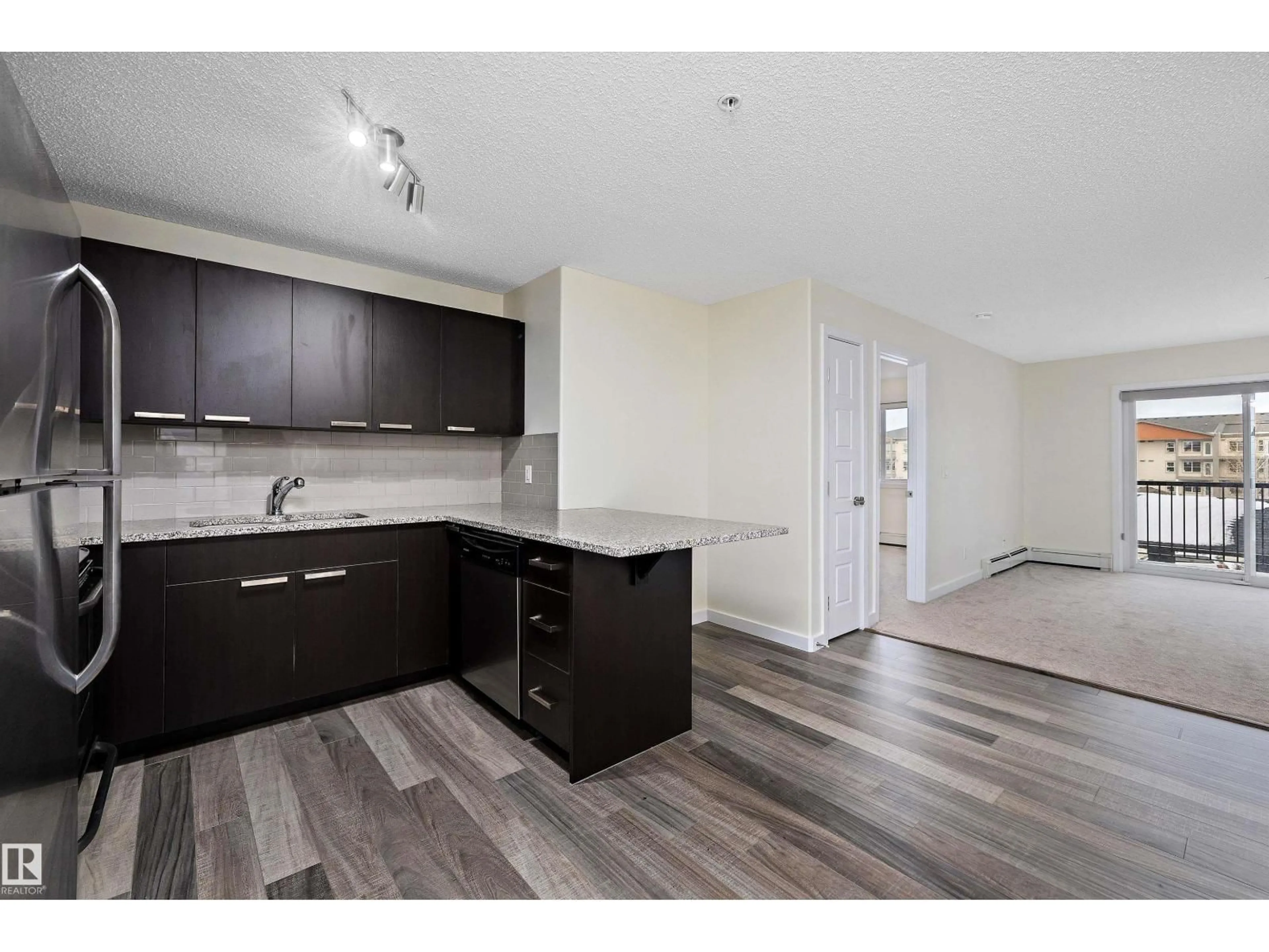 Open concept kitchen, wood/laminate floor for 323 - 14808 125 ST NW, Edmonton Alberta T5X0G1