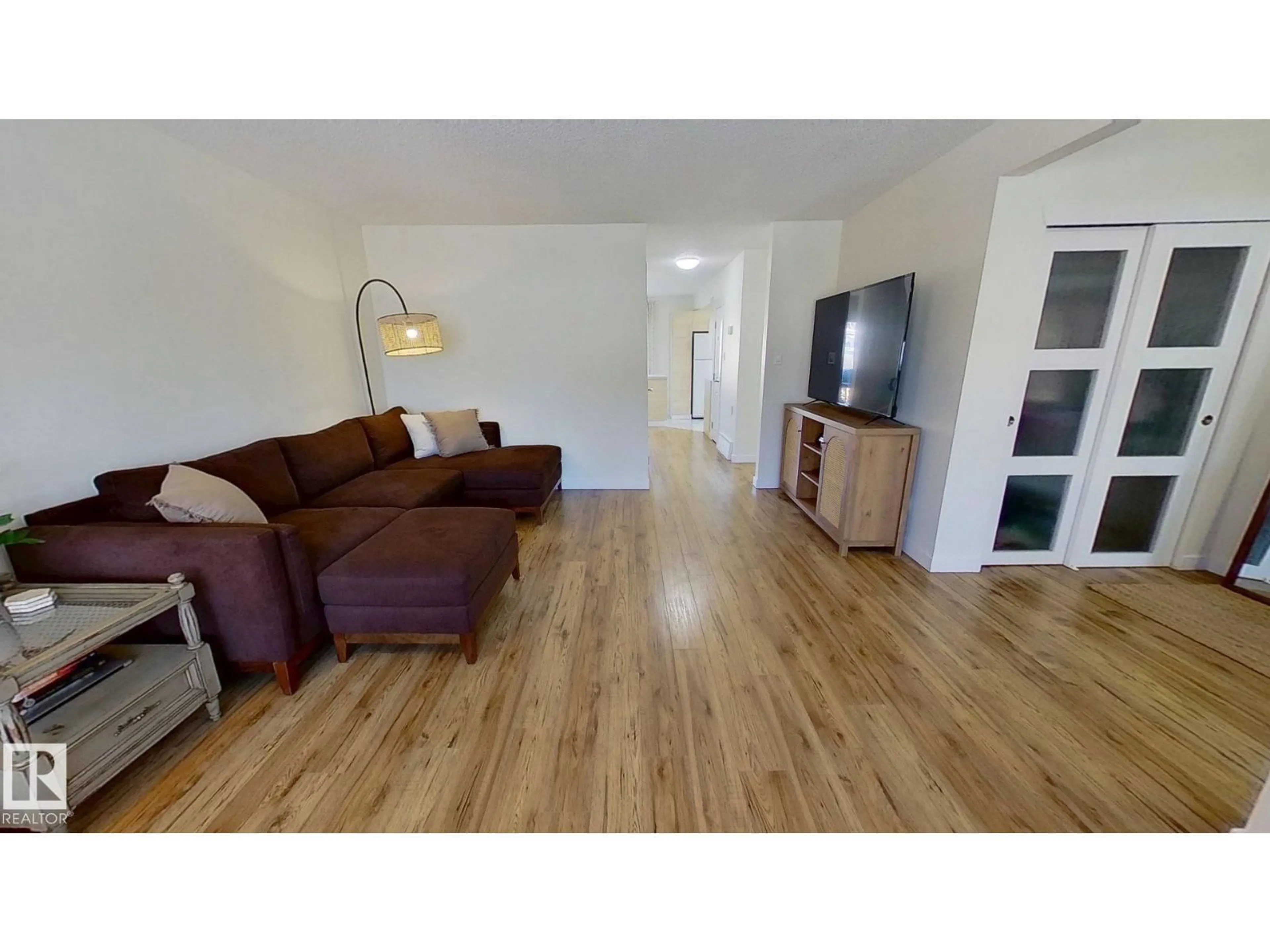 Living room with furniture, wood/laminate floor for 11935 57 ST, Edmonton Alberta T5W3V7