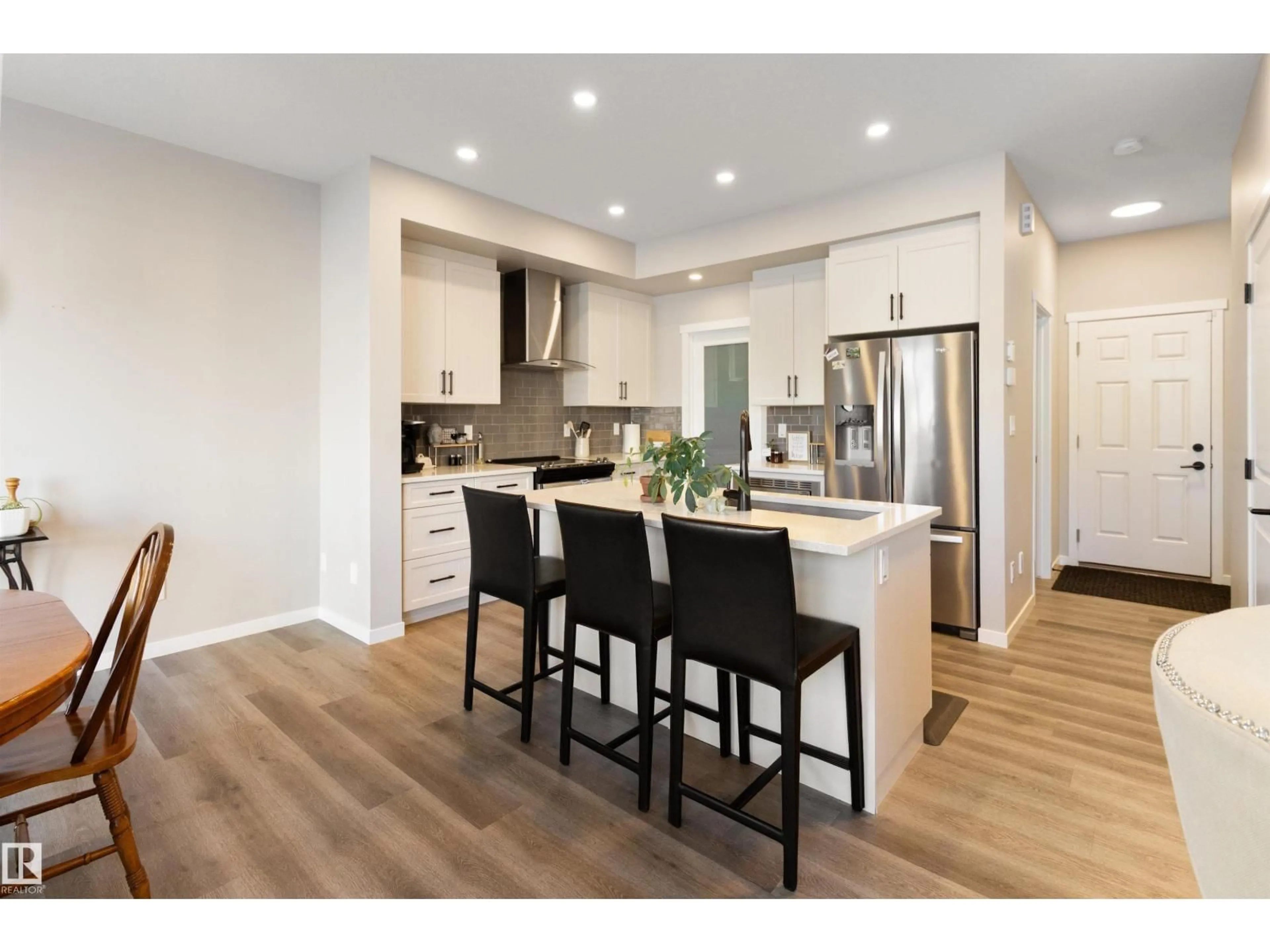 Open concept kitchen, wood/laminate floor for 22706 95A AV, Edmonton Alberta T5T7H4