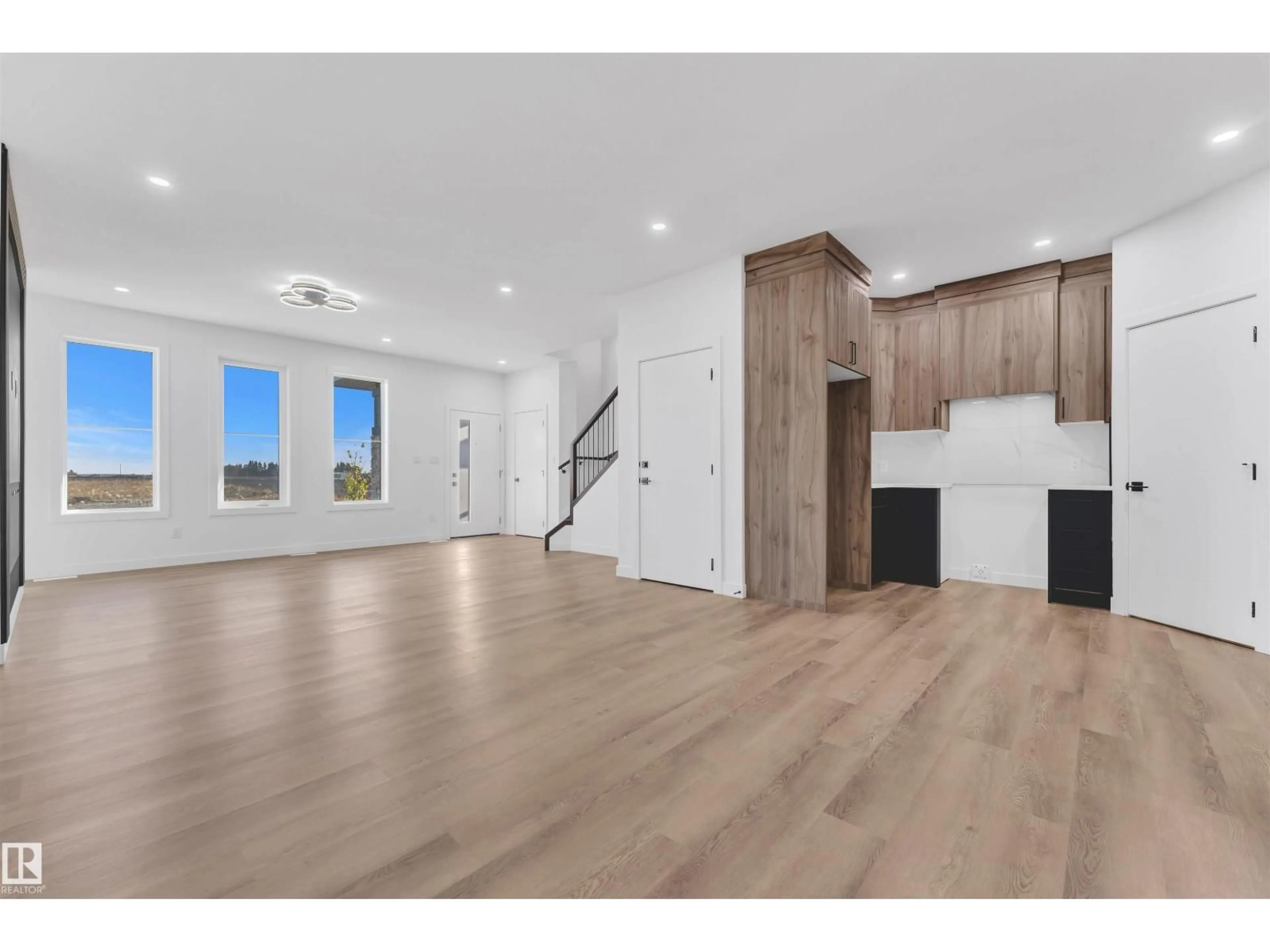 Open concept kitchen, wood/laminate floor for 3606 39 AV, Beaumont Alberta T4X2C5