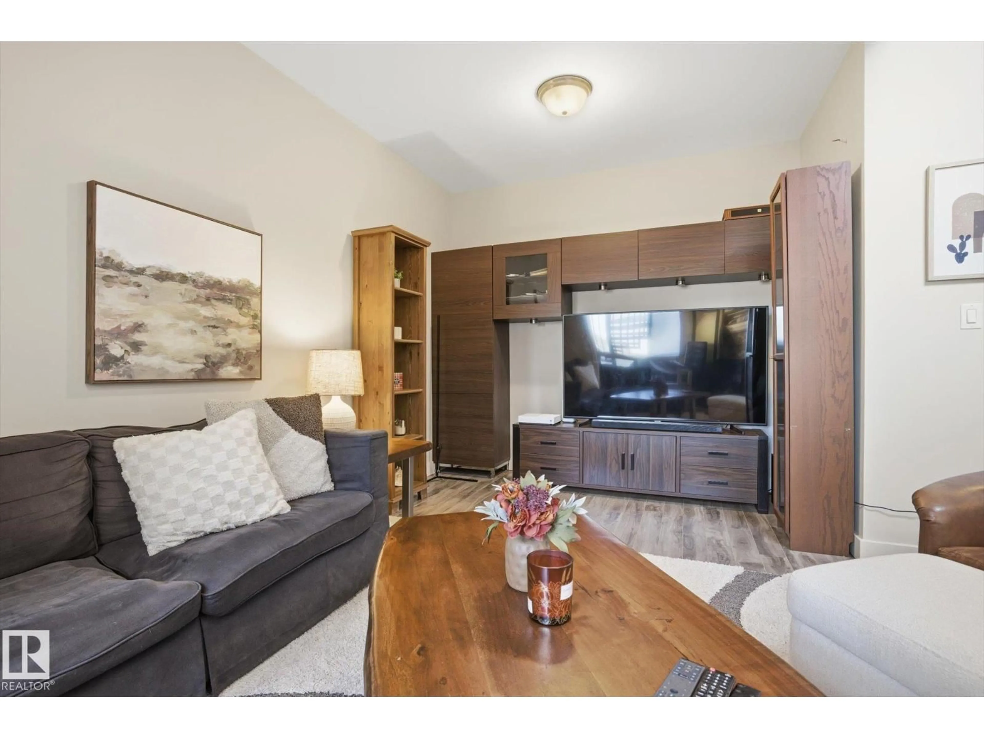 Living room with furniture, wood/laminate floor for 10235 NW - 618 112 ST, Edmonton Alberta T5K1M7