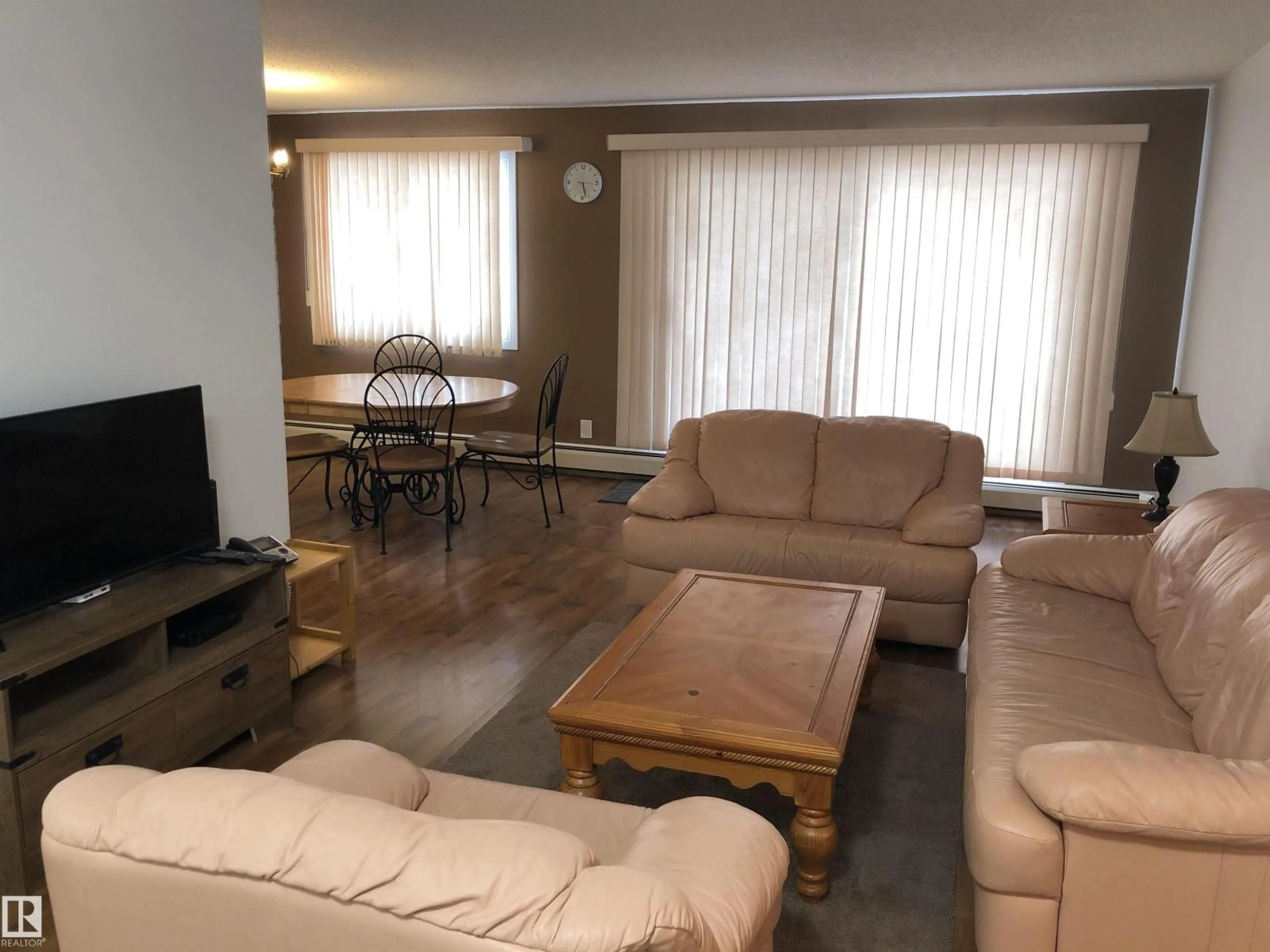 Living room with furniture, wood/laminate floor for 201 - 14825 51 AV, Edmonton Alberta T6H5G4