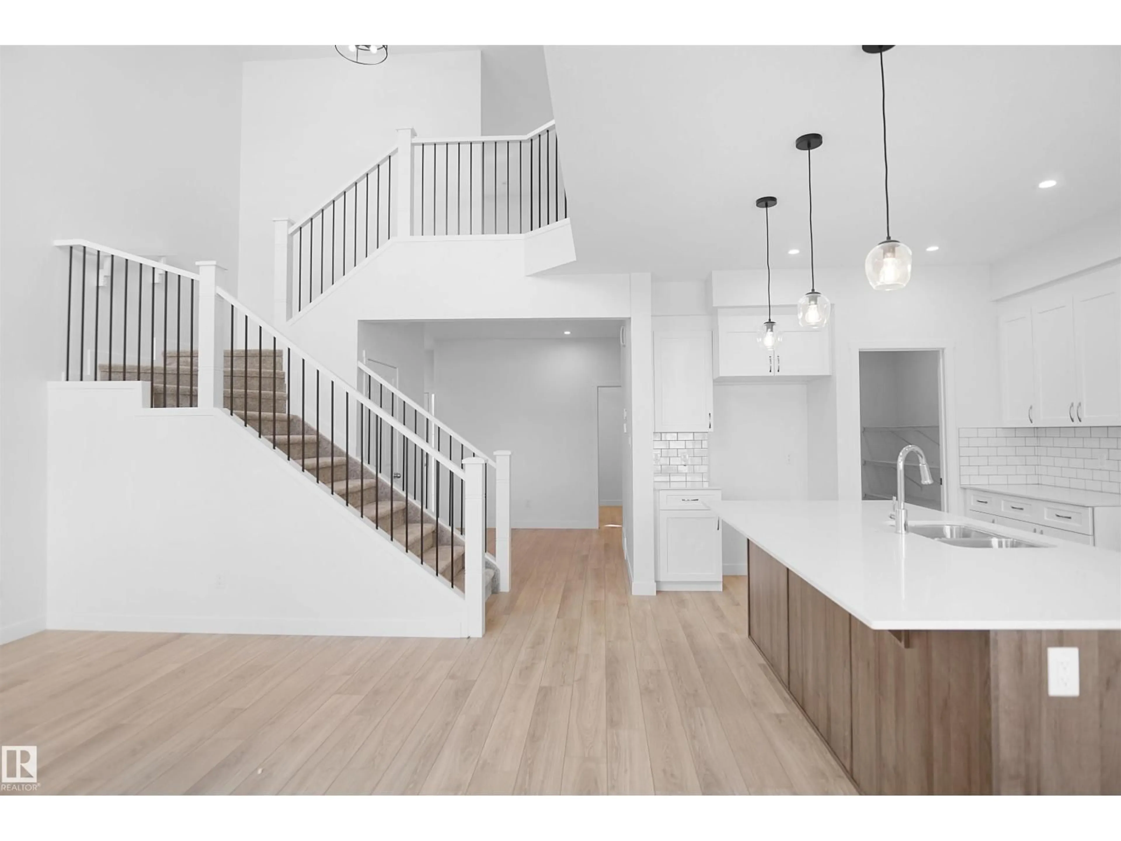 Open concept kitchen, wood/laminate floor for 2603 15 AV, Edmonton Alberta T6T2N5