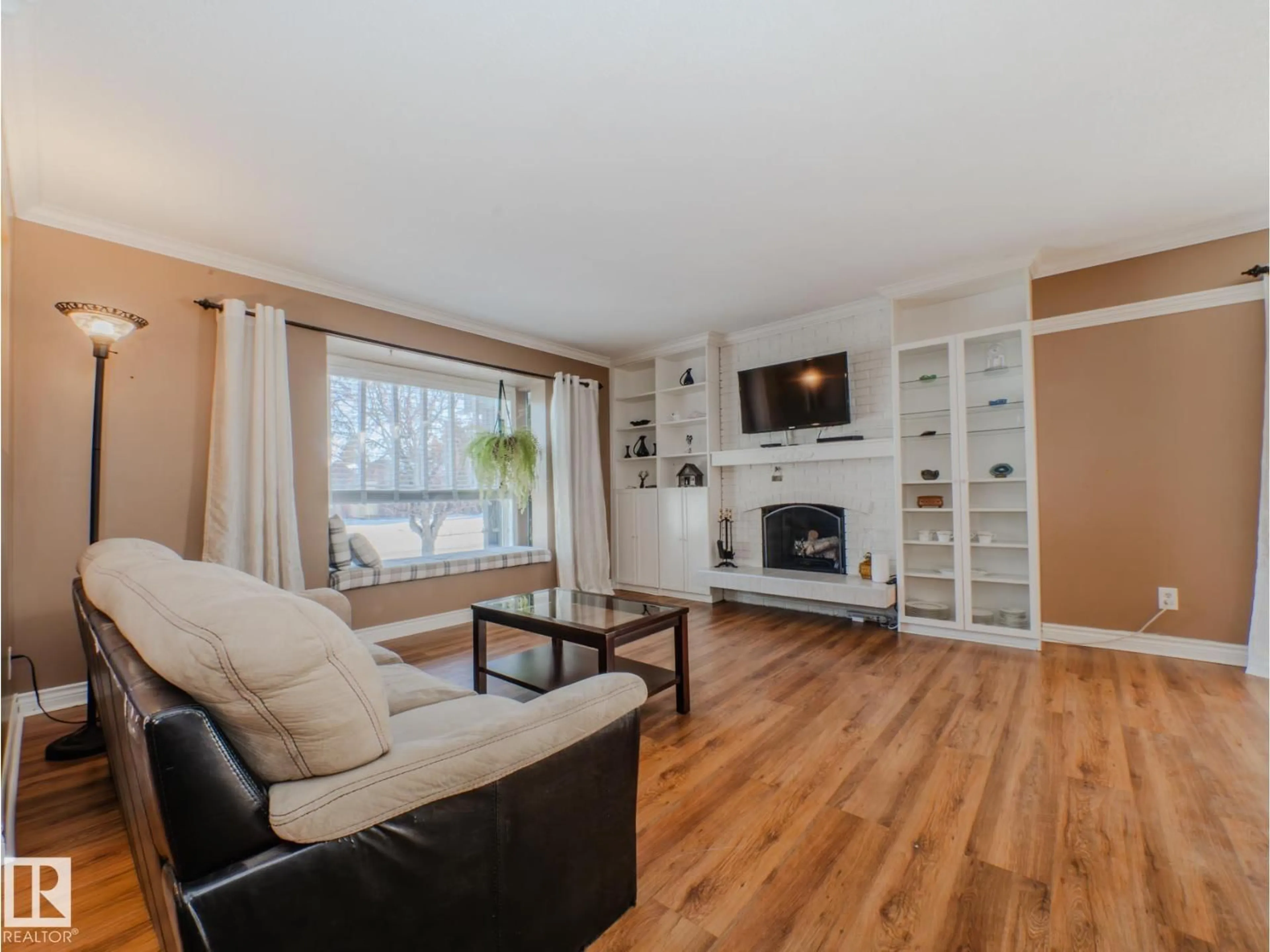 Living room with furniture, wood/laminate floor for NW - 3204 113B ST, Edmonton Alberta T6J3T7