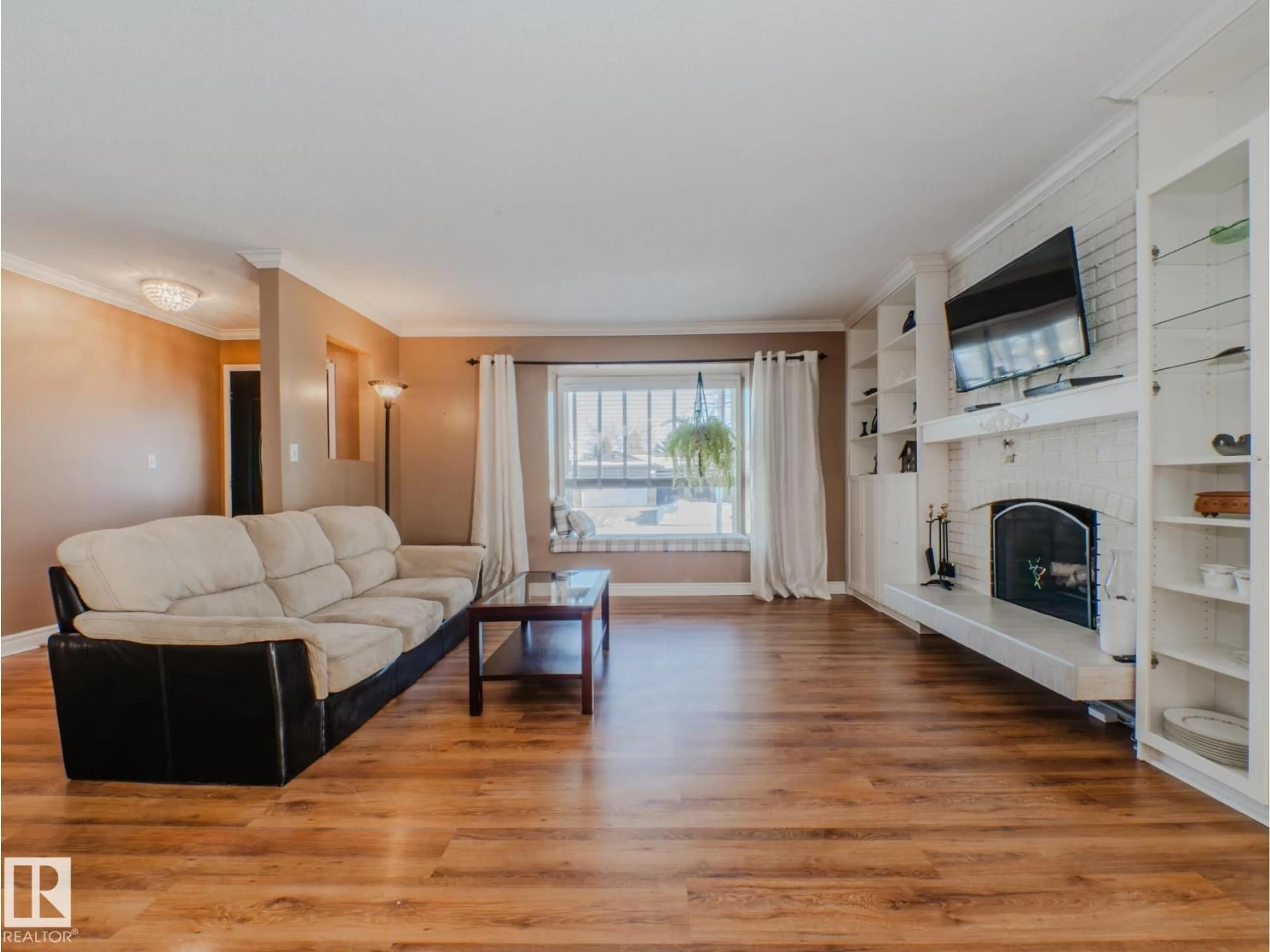 Living room with furniture, wood/laminate floor for NW - 3204 113B ST, Edmonton Alberta T6J3T7