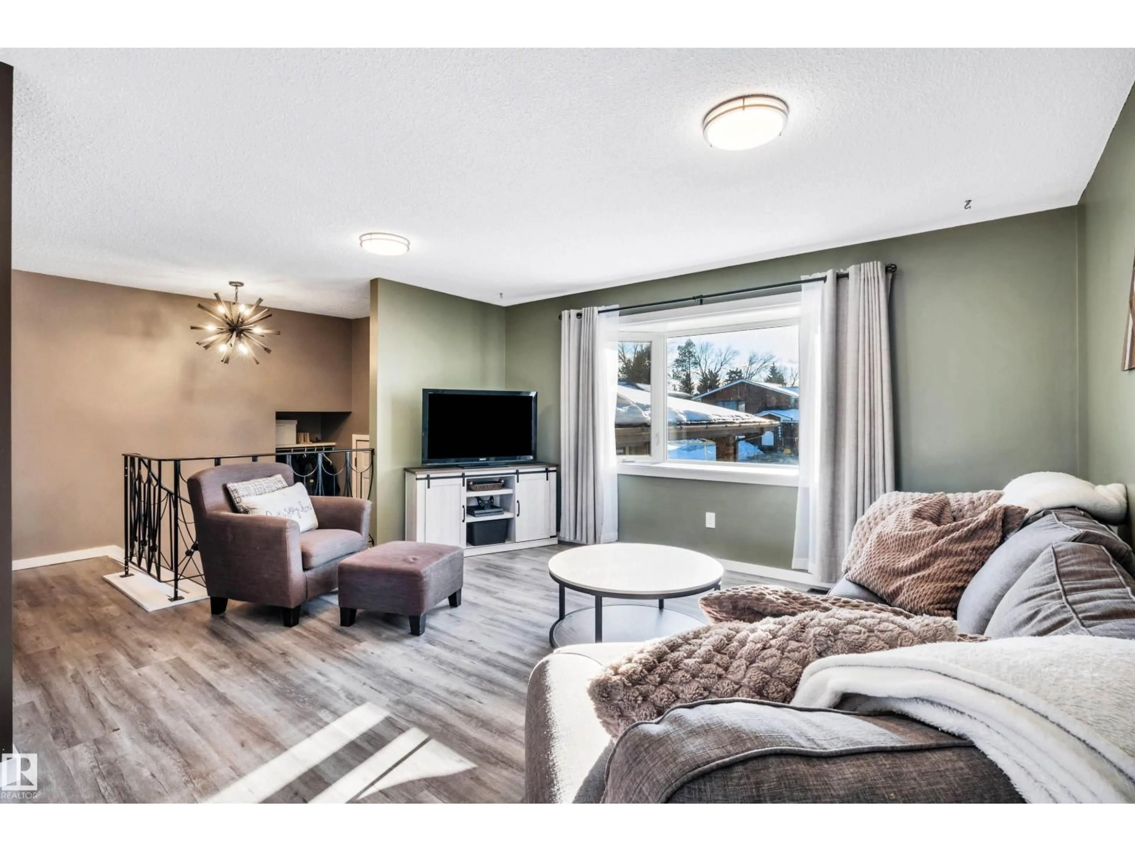 Living room with furniture, wood/laminate floor for NW - 8612 33 AV, Edmonton Alberta T6K2Y1