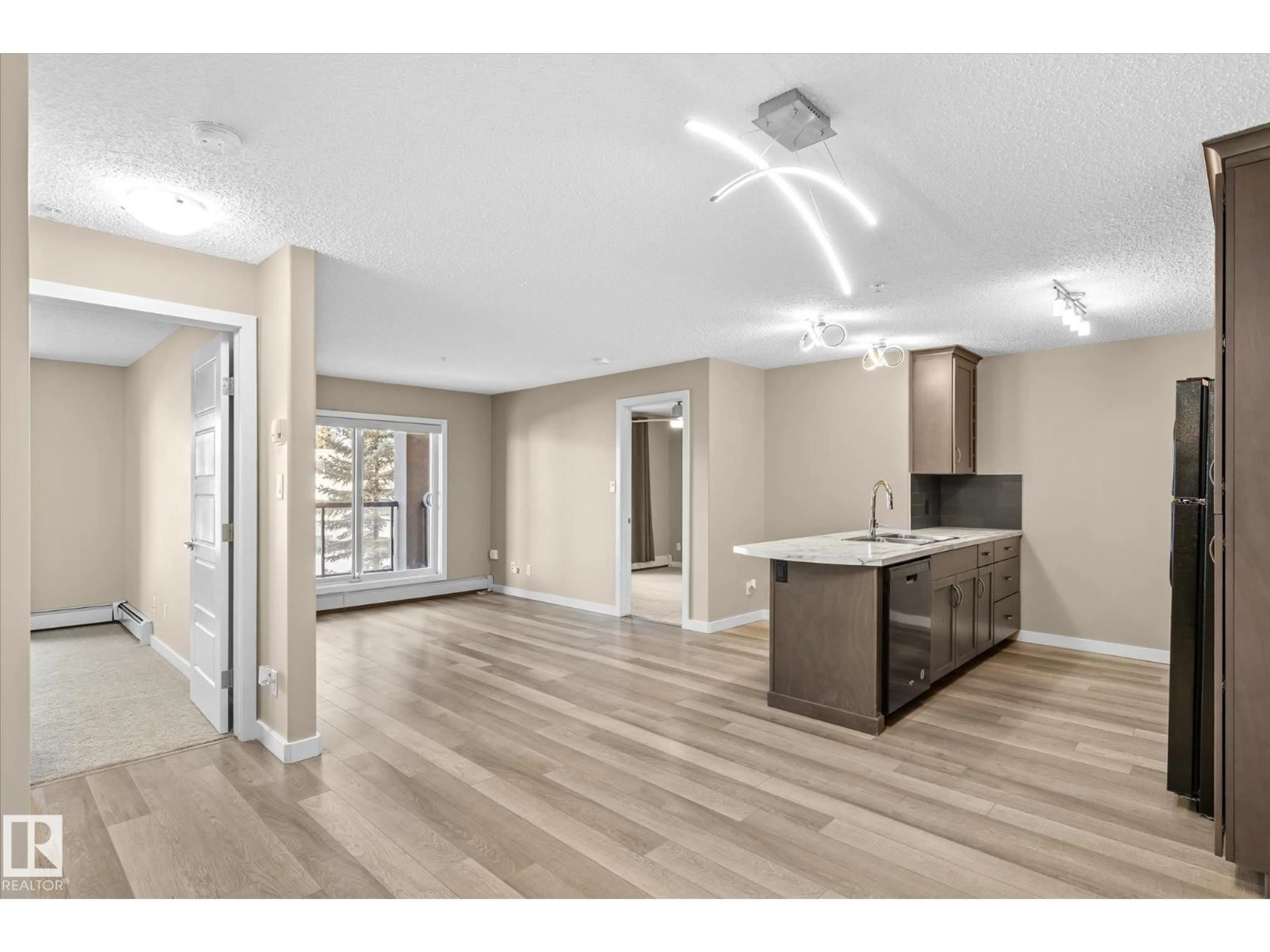 Open concept kitchen, wood/laminate floor for 257 - 7805 71 ST NW, Edmonton Alberta T6B3V6