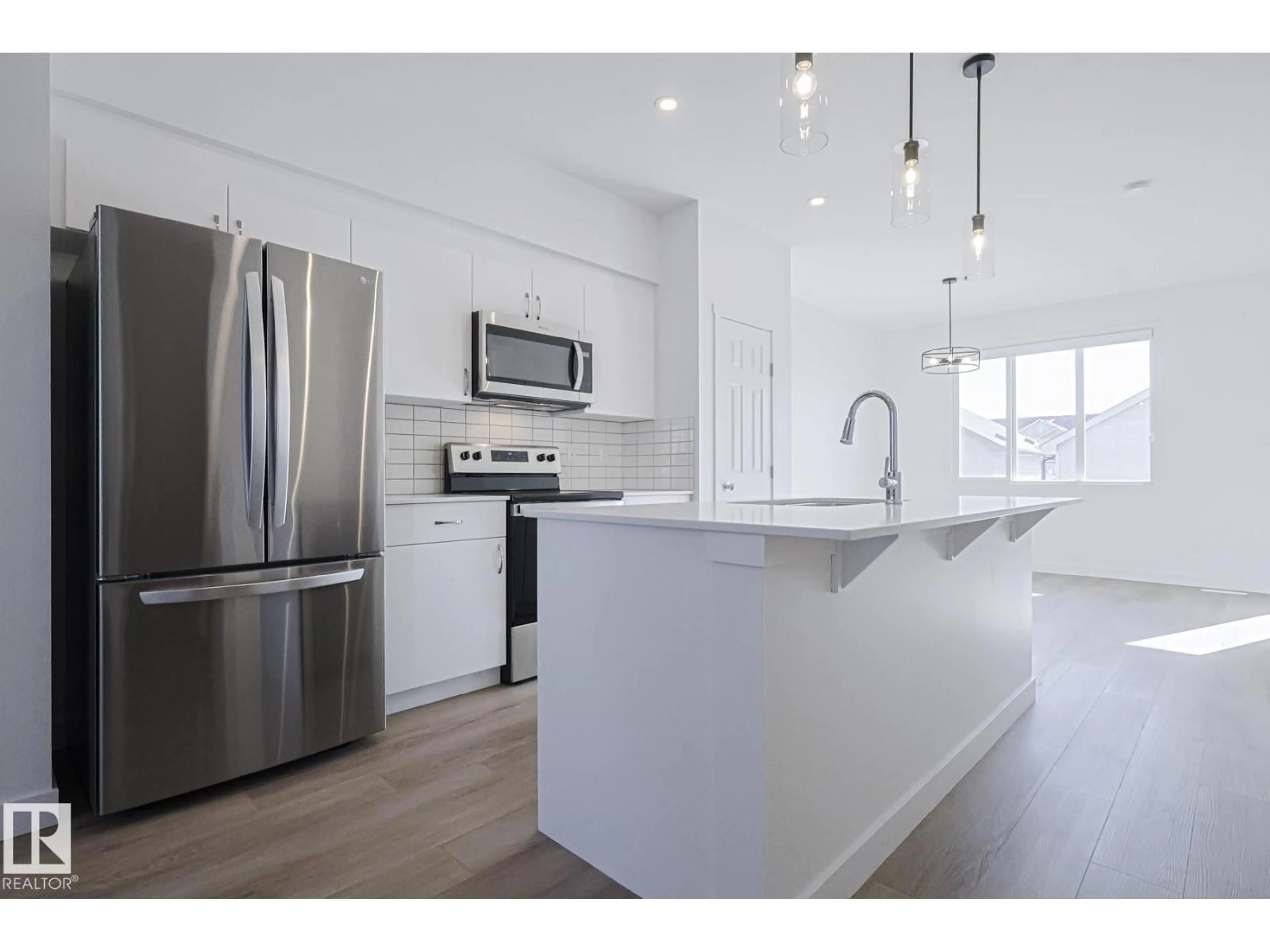 Open concept kitchen, wood/laminate floor for SW - 6343 KING WD, Edmonton Alberta T6W5P1