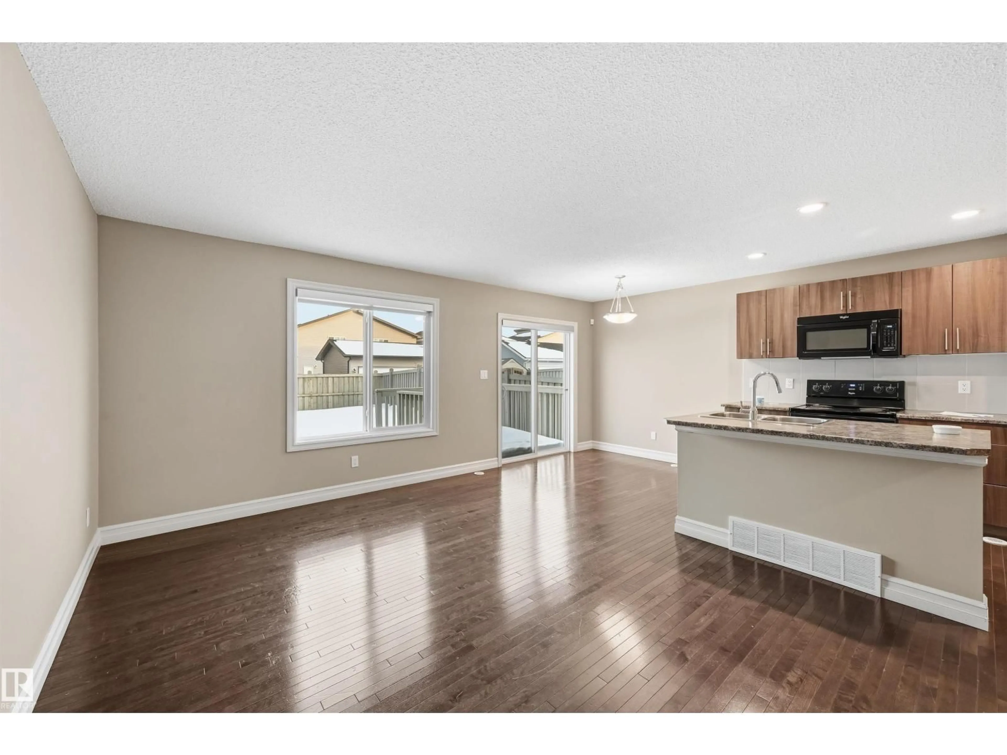 Open concept kitchen, wood/laminate floor for 6833 CARDINAL LI SW, Edmonton Alberta T6W1Z1