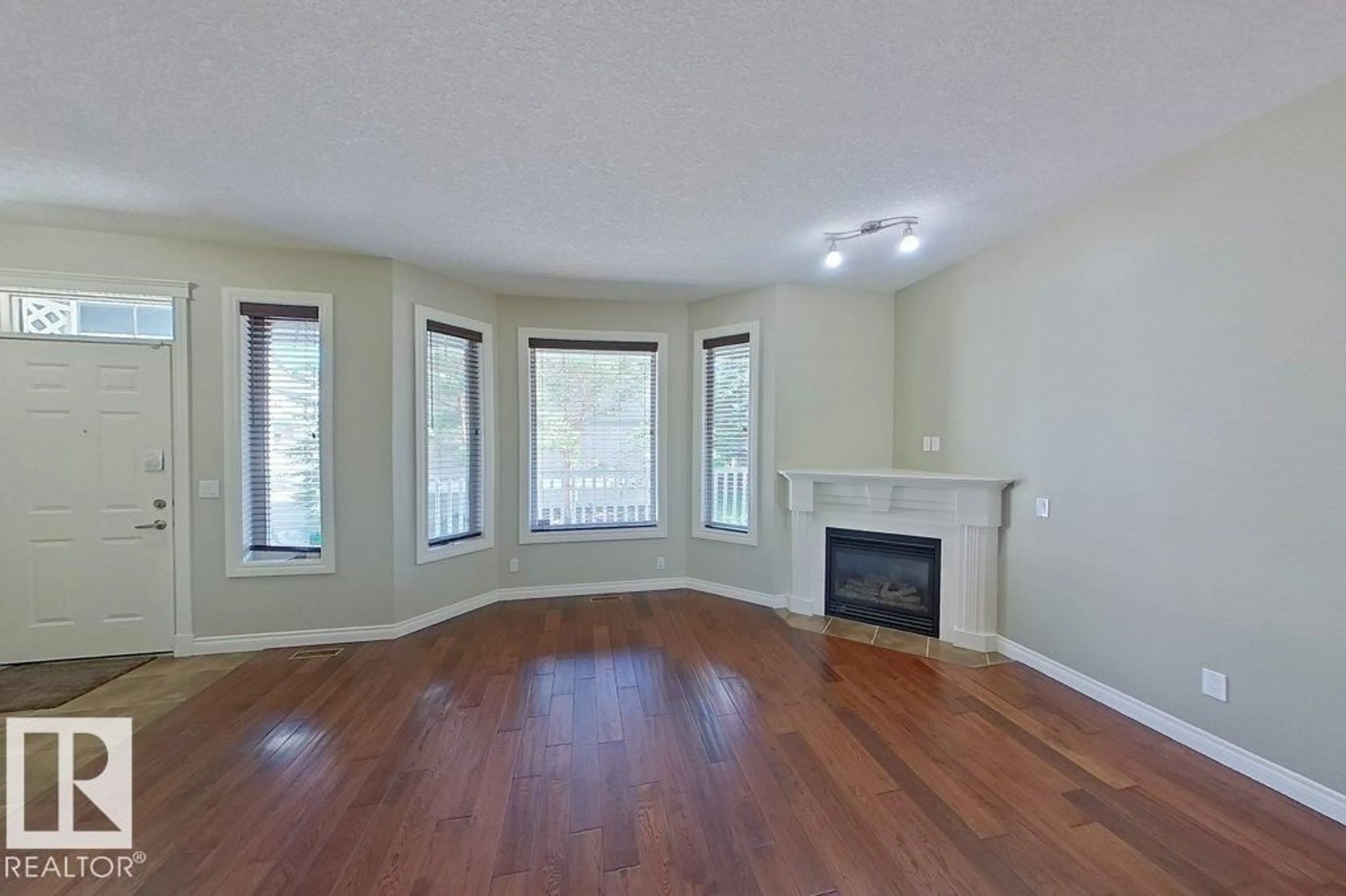 Living room with furniture, wood/laminate floor for #10 - 903 RUTHERFORD RD, Edmonton Alberta T6W1N9