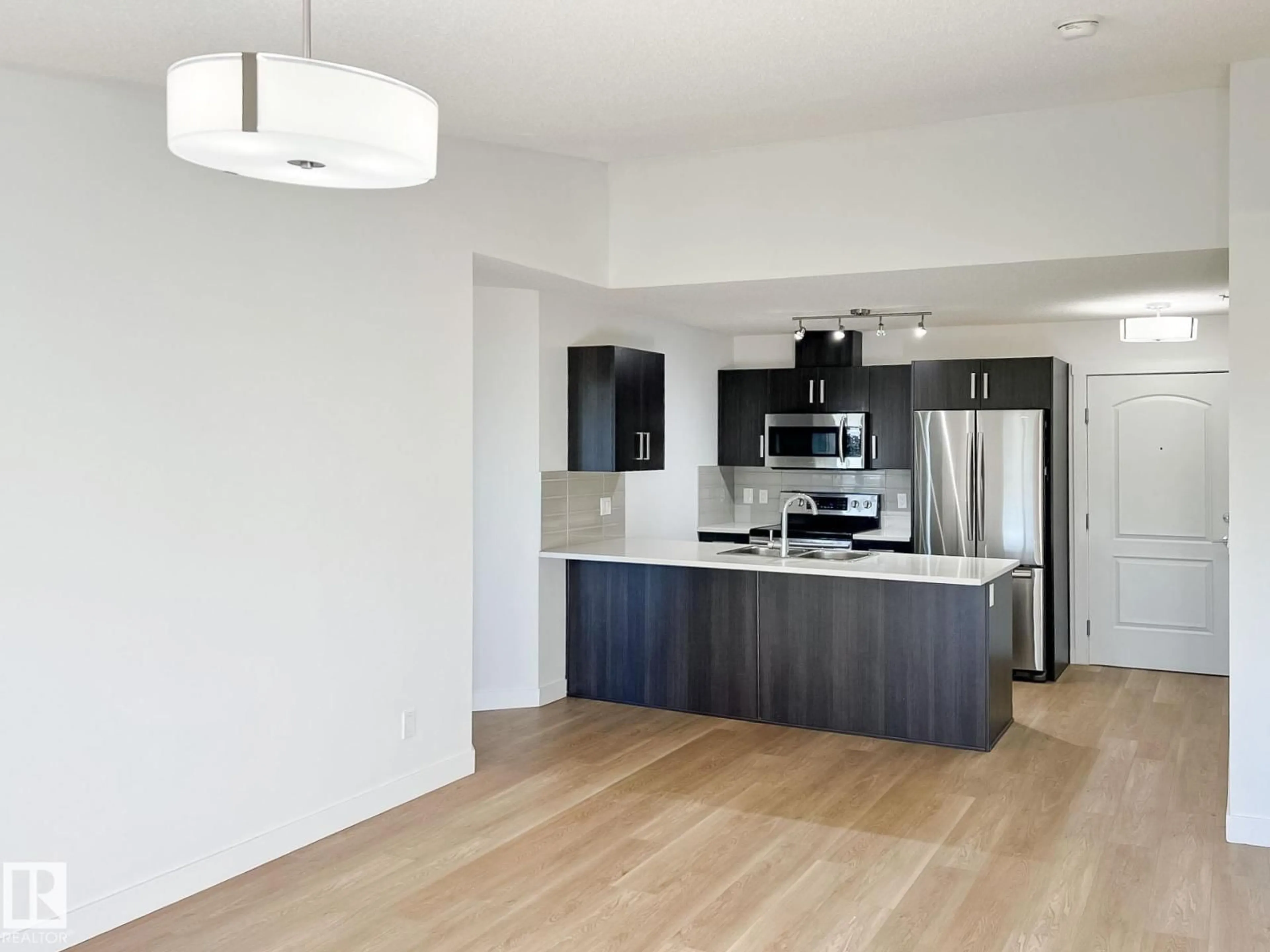 Open concept kitchen, wood/laminate floor for 406 - 667 WATT BV, Edmonton Alberta T6X0Y2