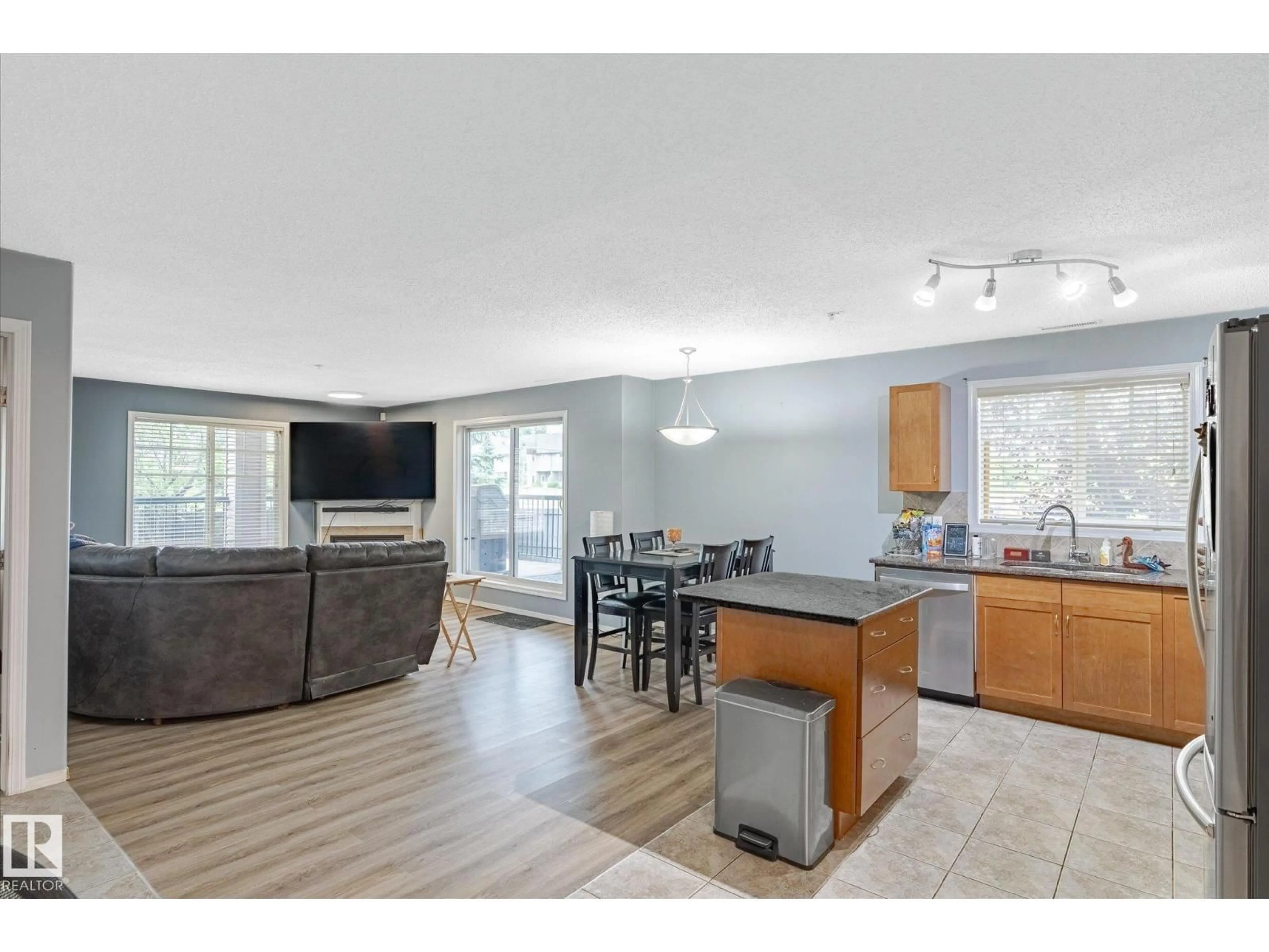 Open concept kitchen, wood/laminate floor for #101 - 2098 BLACKMUD CREEK DR, Edmonton Alberta T6W1T7