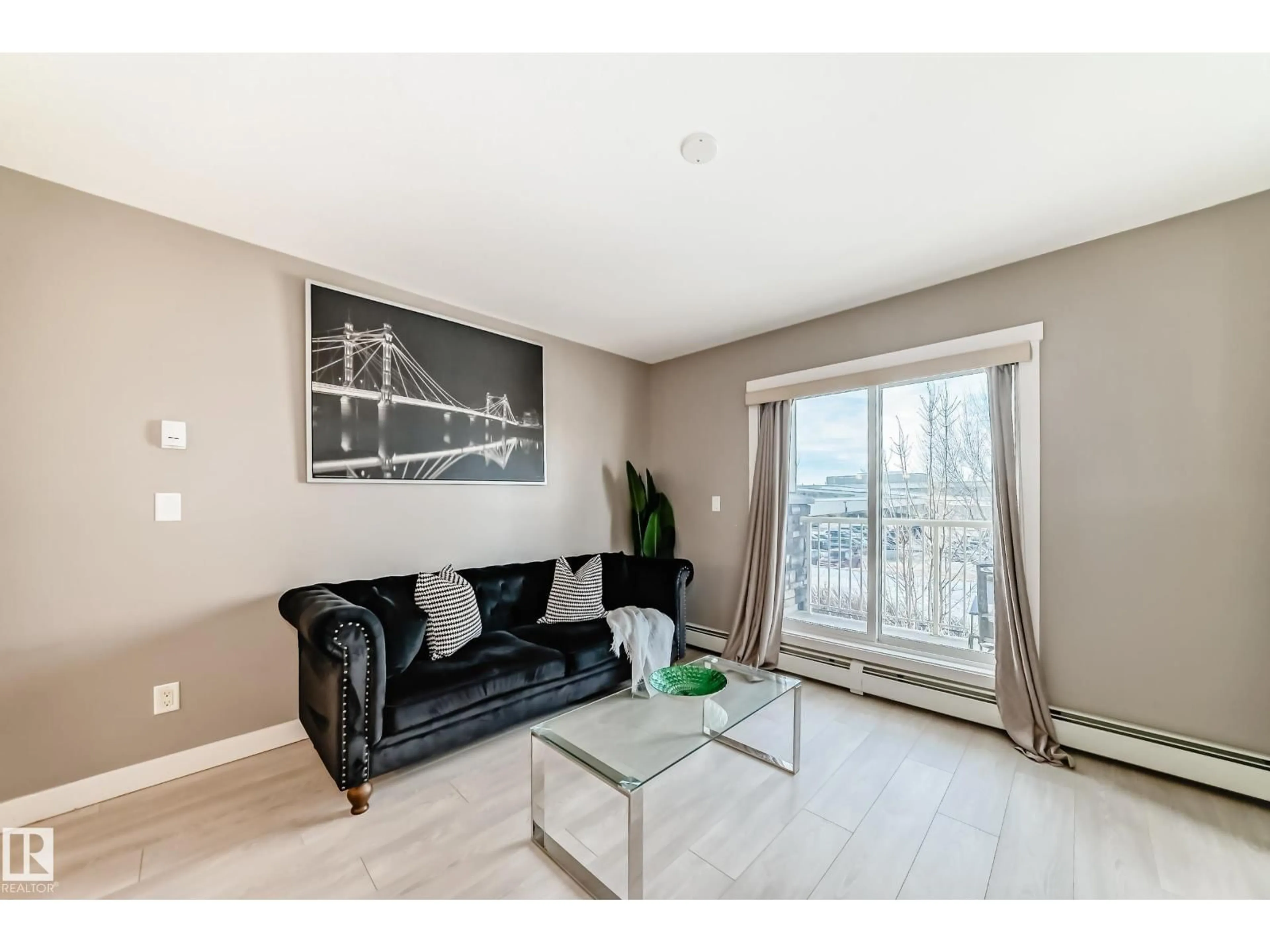 Living room with furniture, wood/laminate floor for #217 - 3670 139 AV, Edmonton Alberta T5Y3N5