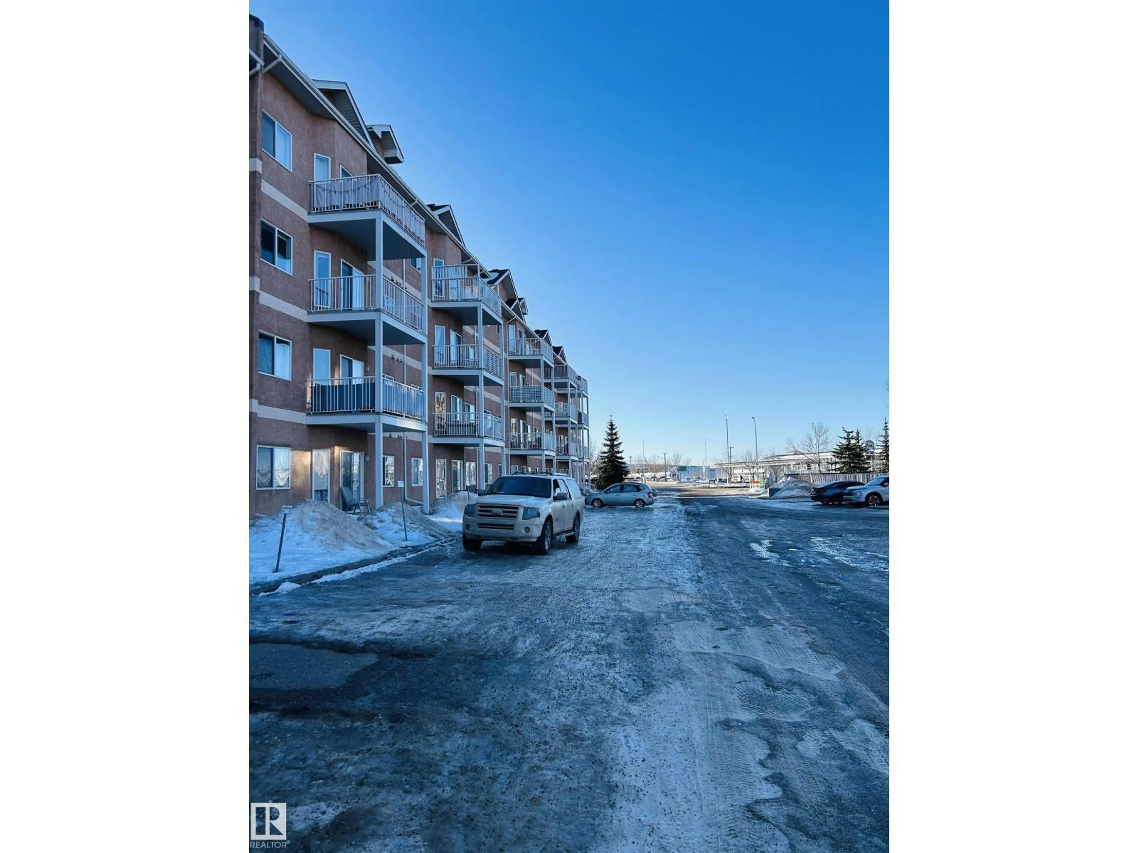 A pic from outside/outdoor area/front of a property/back of a property/a pic from drone, street for #214 - 4304 139 AV, Edmonton Alberta T5Y0H6