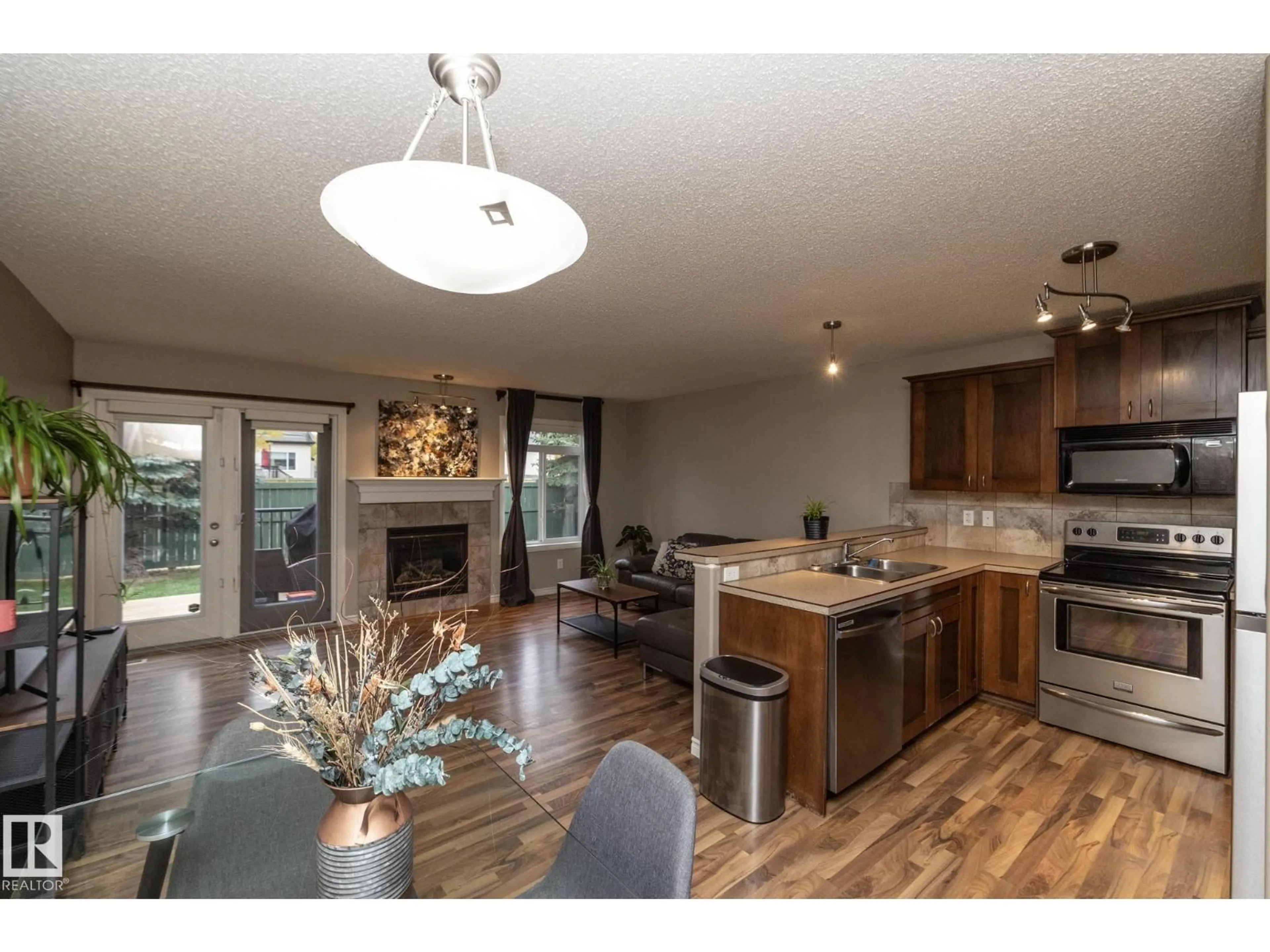 Open concept kitchen, wood/laminate floor for #6 - 10 WOODCREST, Fort Saskatchewan Alberta T8L0C7