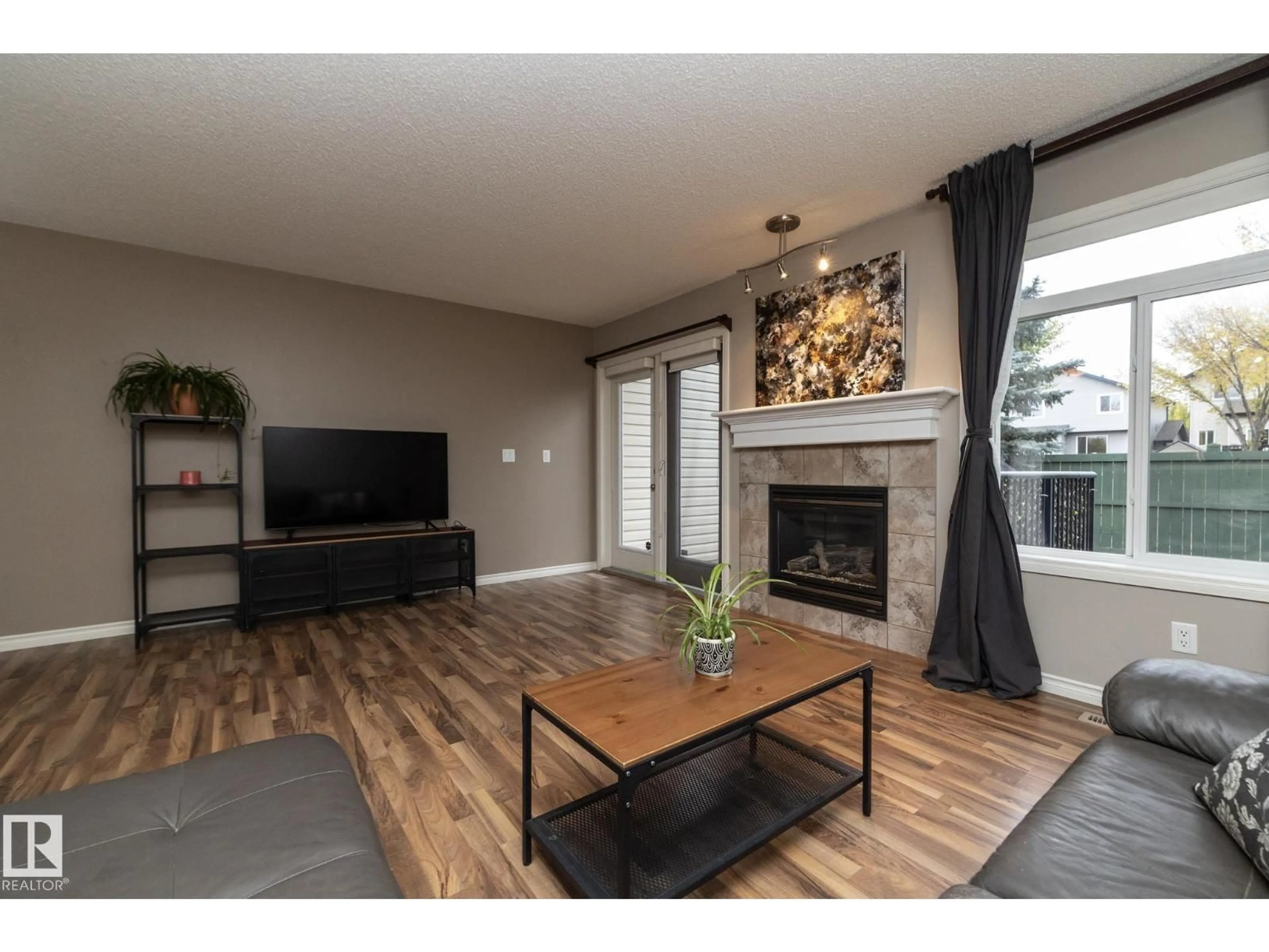 Living room with furniture, wood/laminate floor for #6 - 10 WOODCREST, Fort Saskatchewan Alberta T8L0C7