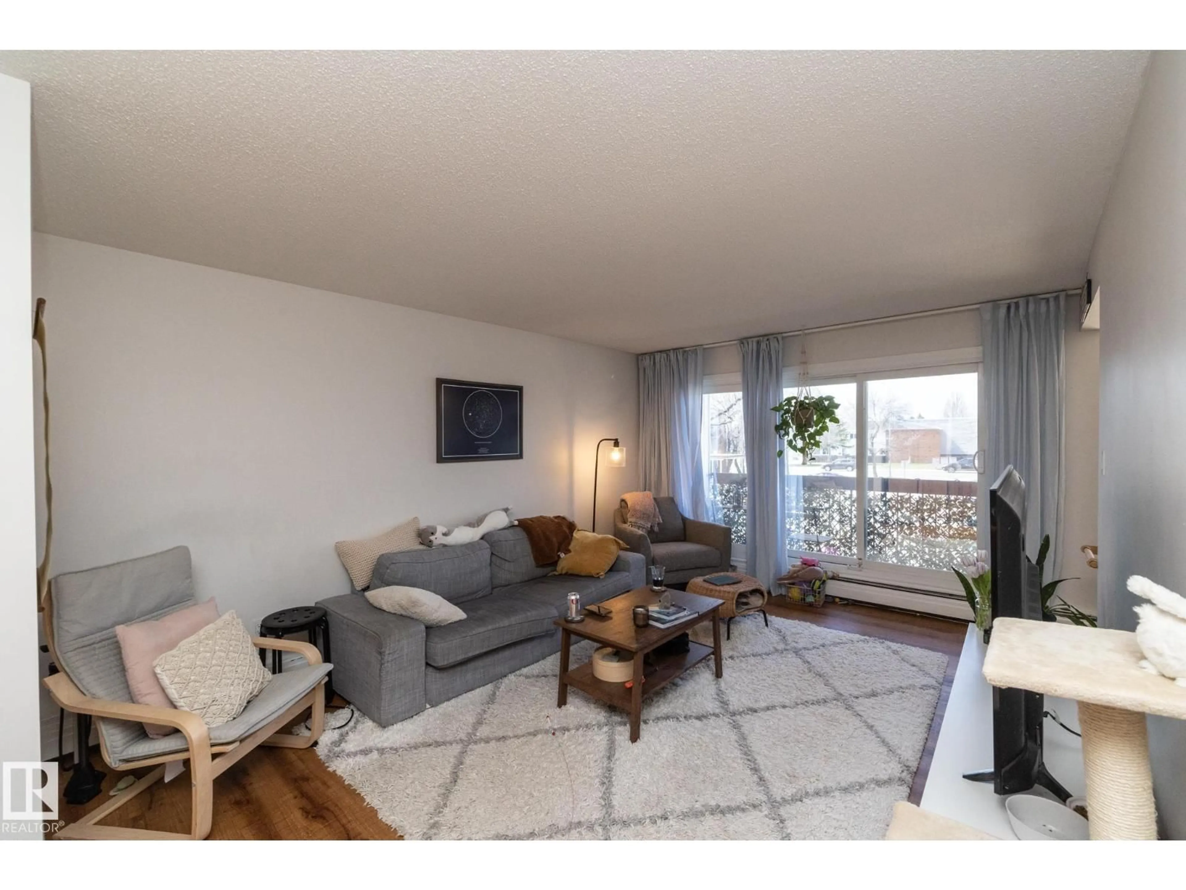 Living room with furniture, wood/laminate floor for 208 - 11455 41 AV NW, Edmonton Alberta T6J0T9