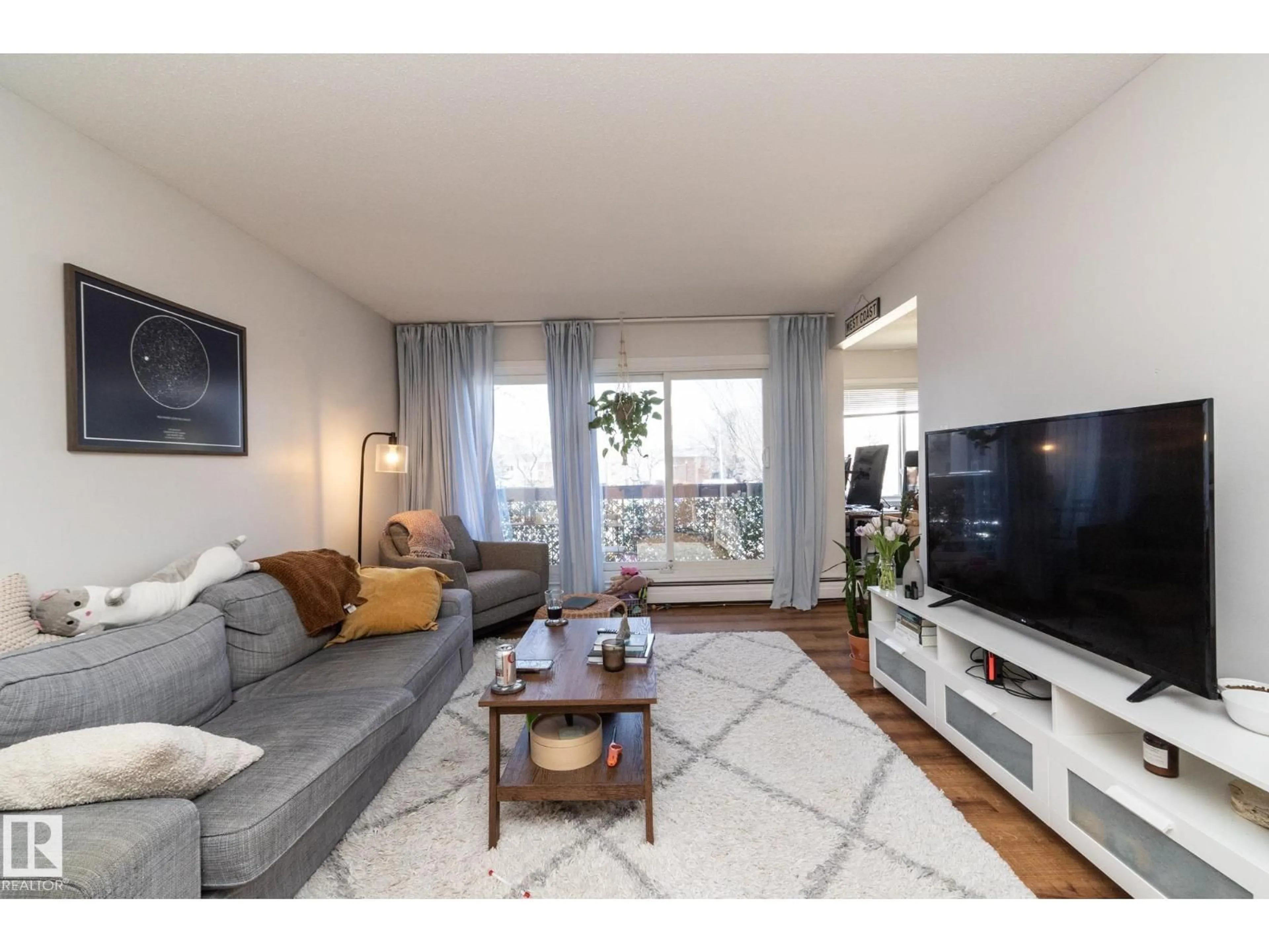 Living room with furniture, wood/laminate floor for 208 - 11455 41 AV NW, Edmonton Alberta T6J0T9