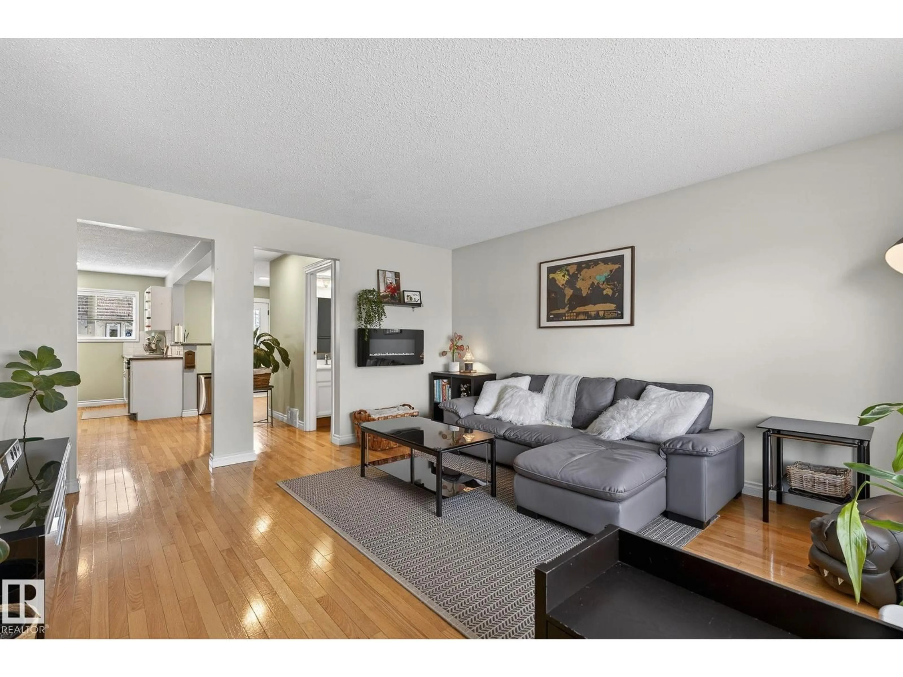 Living room with furniture, wood/laminate floor for 11349 22 AV, Edmonton Alberta T6J4V8