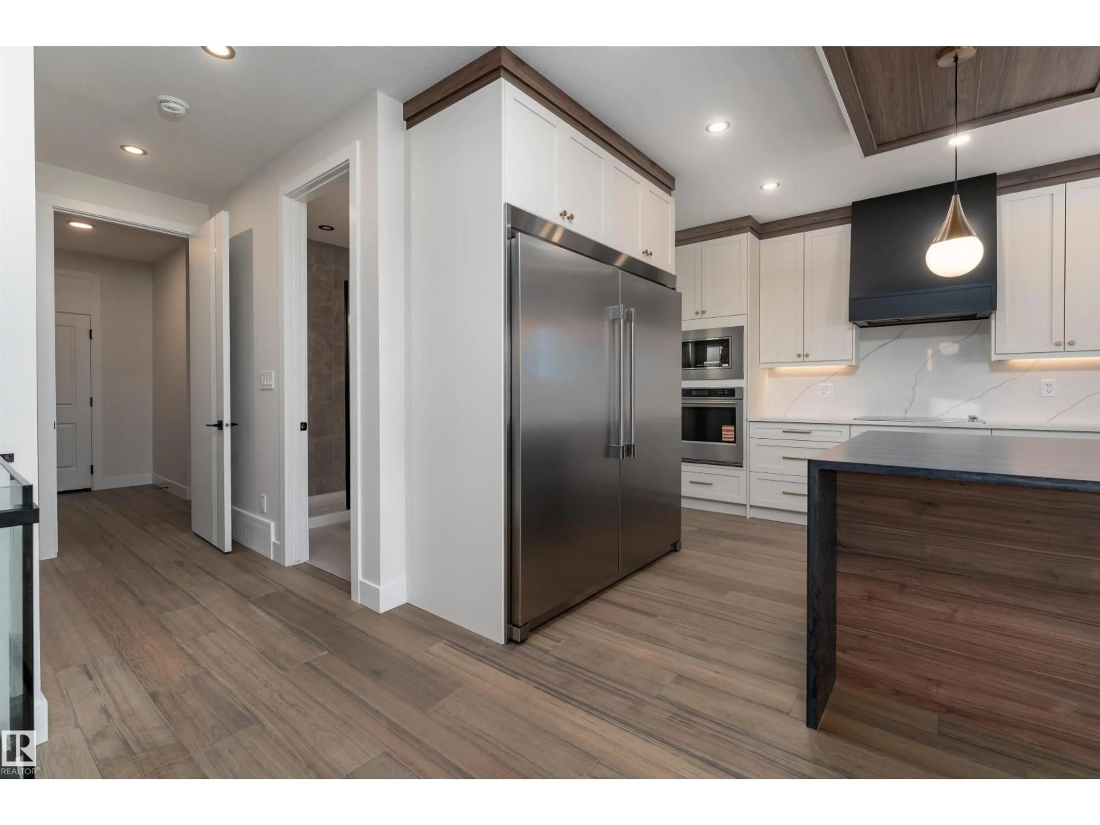 Open concept kitchen, wood/laminate floor for SW - 7077 KIVIAQ CR, Edmonton Alberta T6W5R3