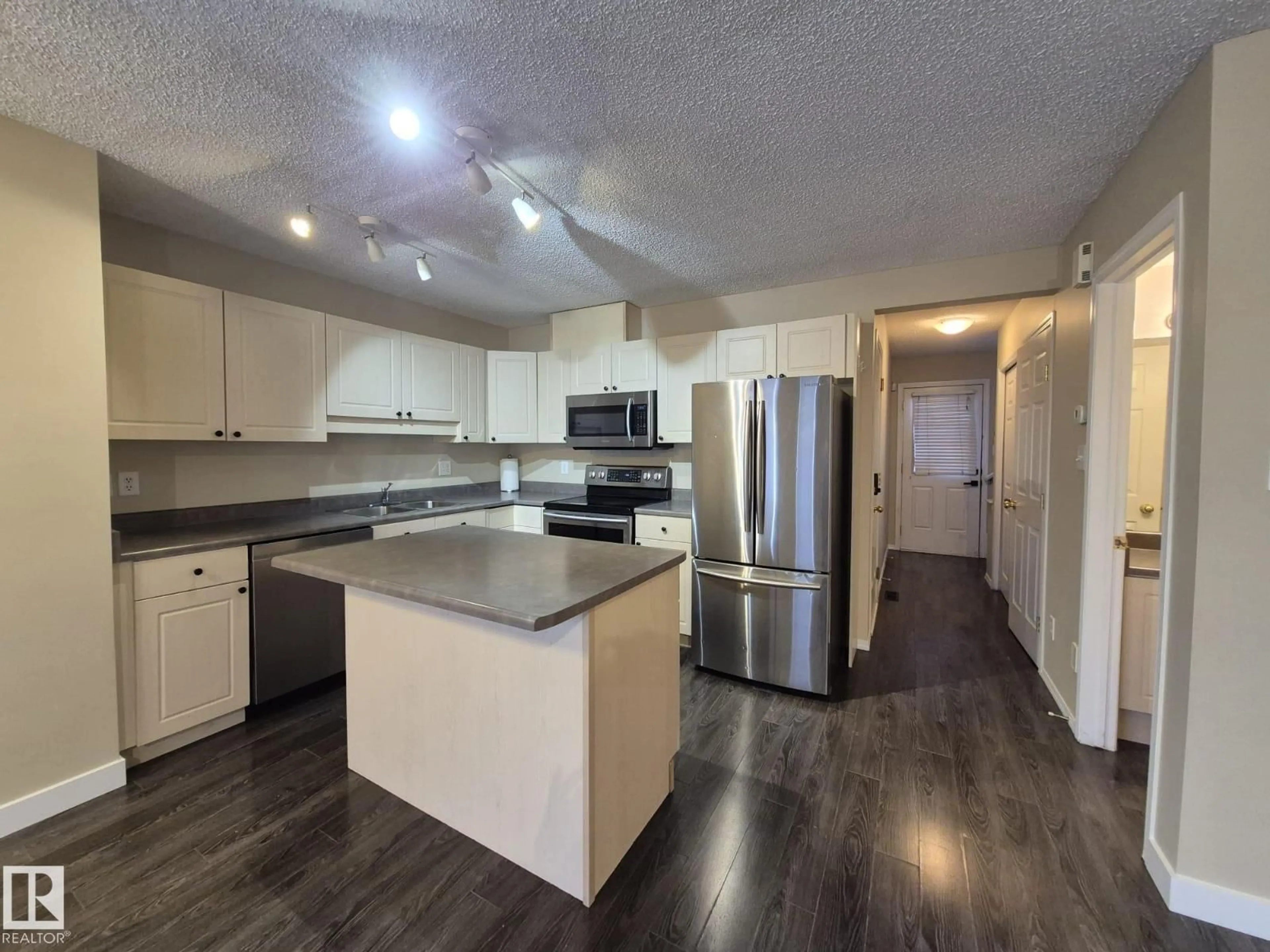 Open concept kitchen, wood/laminate floor for 2965 23 ST, Edmonton Alberta T6T2B3