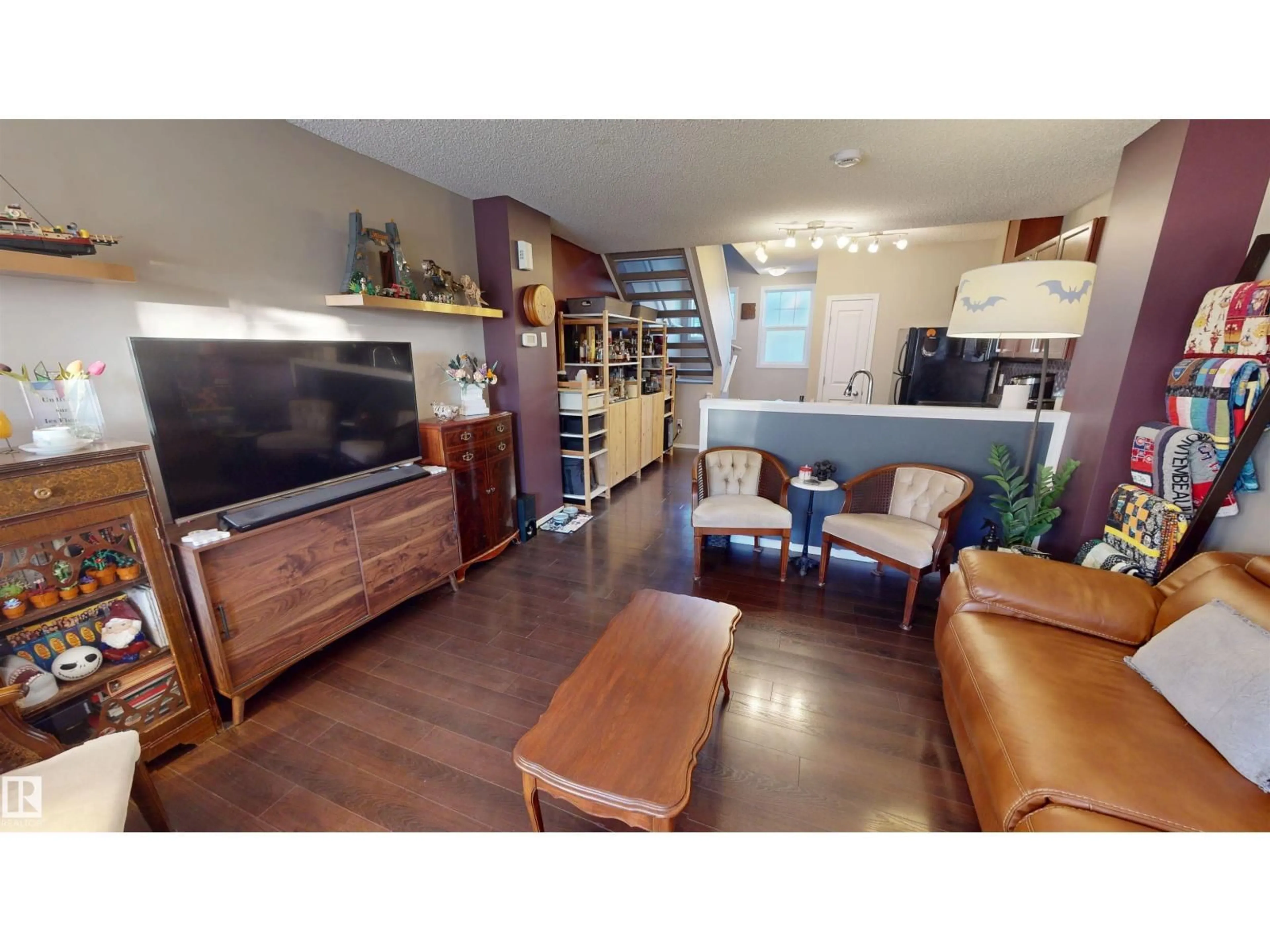 Living room with furniture, wood/laminate floor for 43 - 5604 199 ST NW, Edmonton Alberta T6M2Z9
