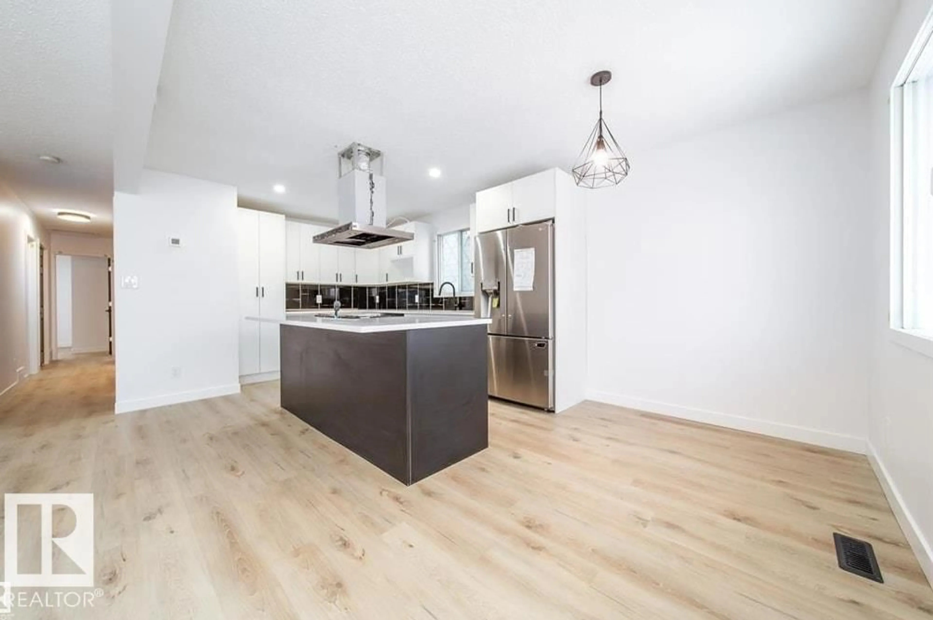 Open concept kitchen, wood/laminate floor for NW - 11523 82 ST, Edmonton Alberta T5B2V7