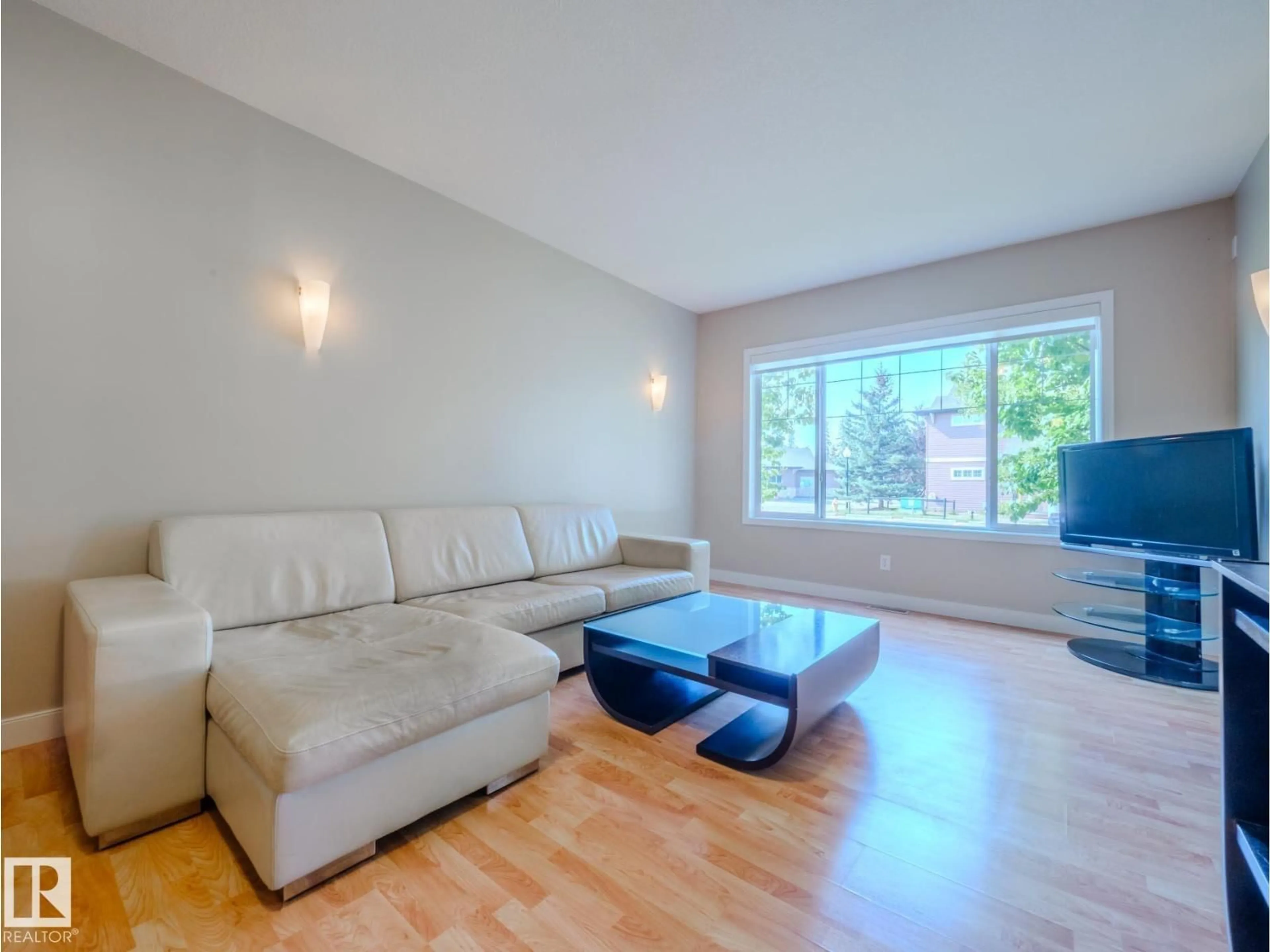 Living room with furniture, wood/laminate floor for 12 - #12 SILVER BERRY RD, Edmonton Alberta T6T0B7