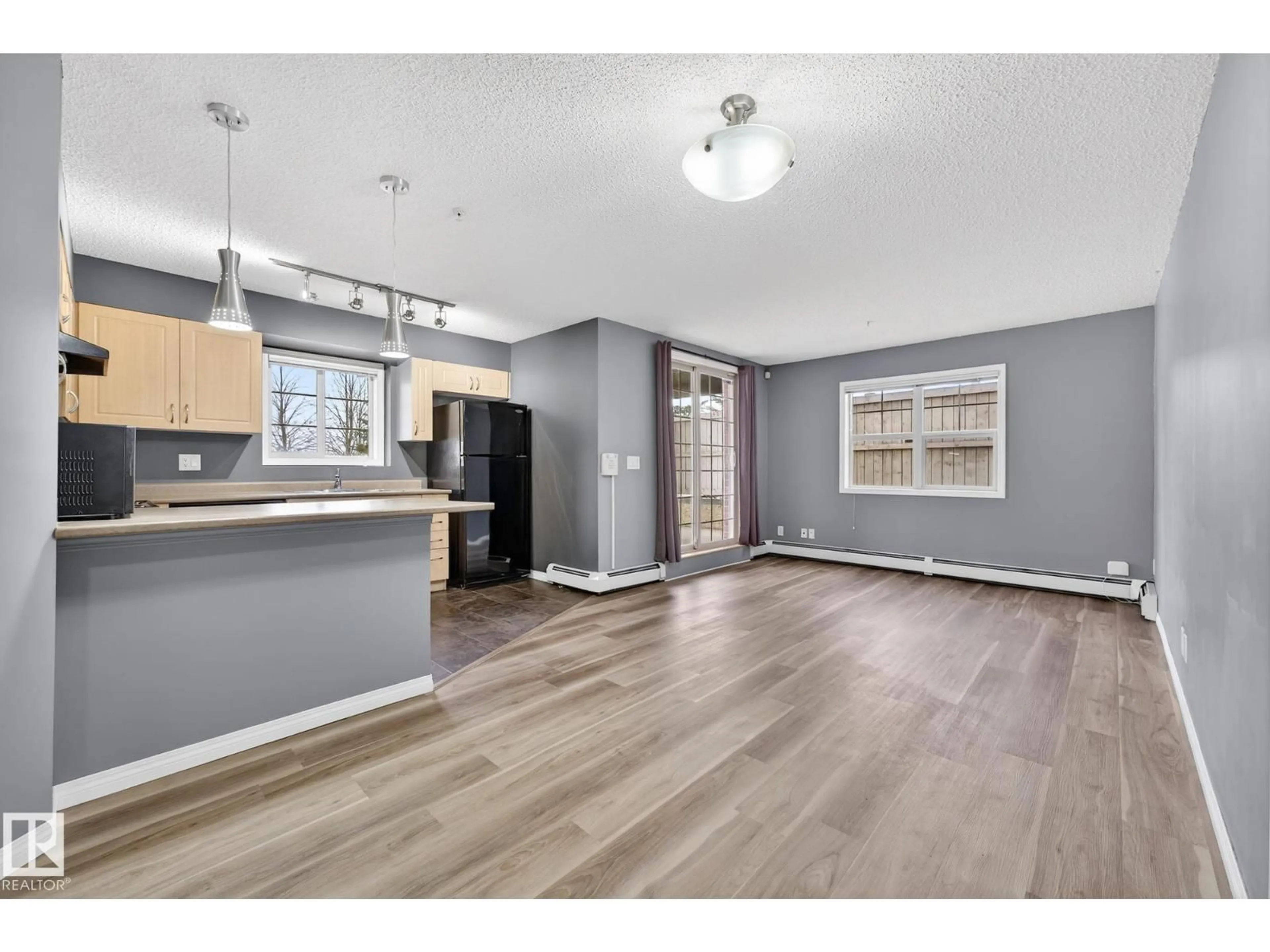 Open concept kitchen, wood/laminate floor for #102 - 11445 ELLERSLIE RD SW, Edmonton Alberta T5W1T1